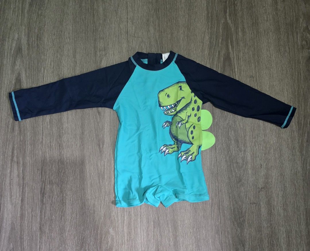 Sandbox Dinosaur Swimsuit rash guard (Category: Babies & Kids Fashion) located in Mandaluyong City. Submitted by ynahh (Listing ID 1420390425, Image 1). Description: - Sandbox dinosaur swimsuit - Teal and navy color scheme - Features a green dinosaur graphic - Long sleeves for sun protection - Convenient zip closure - Unique dinosaur tail detail at the back issue * nabungi lang po zipper sa likod konti but still can be used. pwede din palitan. us