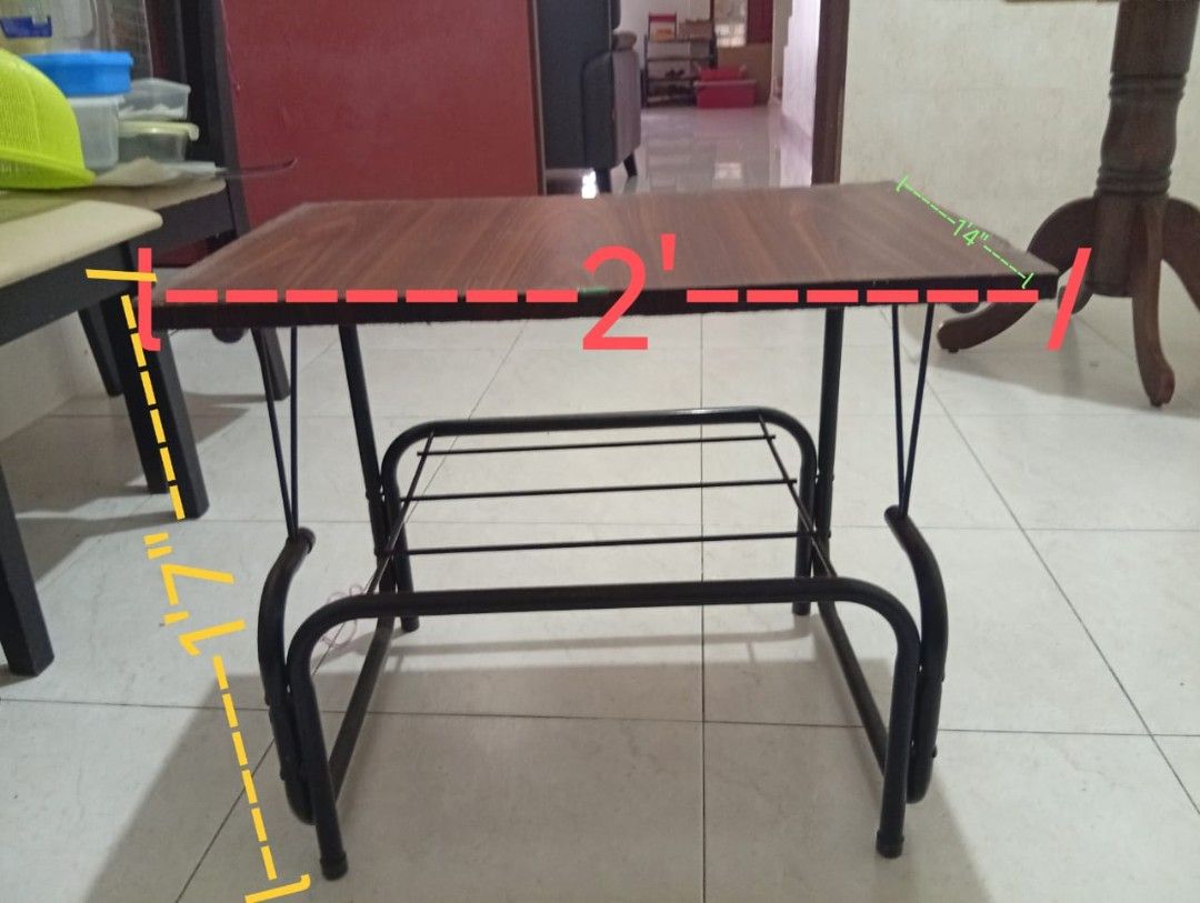 Small Study Table (Category: Tables & Sets) located in Kuala Lumpur. Submitted by mmmm985128 (Listing ID 1420366250, Image 2). Description: - Dark brown tabletop with a sleek black metal frame. - Features a convenient lower shelf for storage. - Dimensions: Approximately 2 feet long, 14 inches wide, and 1.7 feet high. - Ideal for small spaces. - Versatile use: Study table or side table..