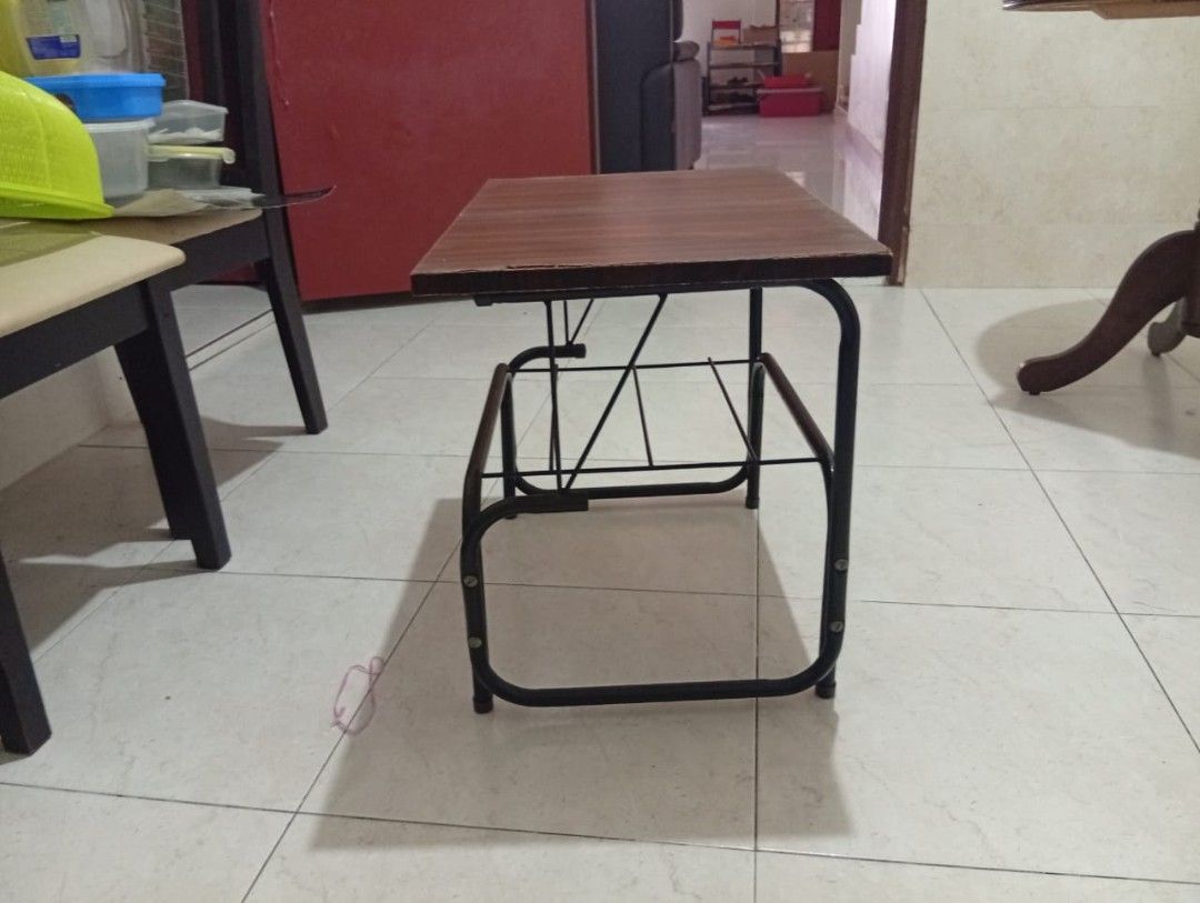 Small Study Table (Category: Tables & Sets) located in Kuala Lumpur. Submitted by mmmm985128 (Listing ID 1420366250, Image 3). Description: - Dark brown tabletop with a sleek black metal frame. - Features a convenient lower shelf for storage. - Dimensions: Approximately 2 feet long, 14 inches wide, and 1.7 feet high. - Ideal for small spaces. - Versatile use: Study table or side table..