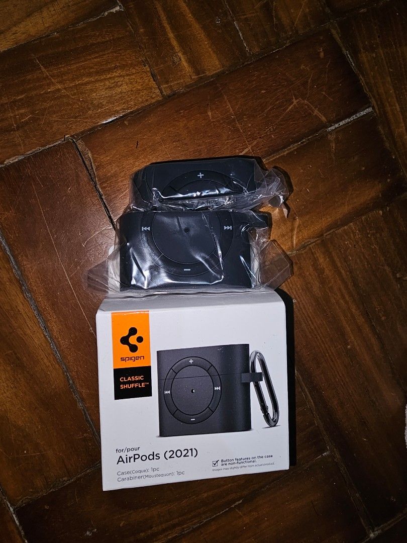 Spigen AirPods (2021) Classic Shuffle Case (Category: Cases & Sleeves) located in General Santos City (Dadiangas). Submitted by pactoderetro (Listing ID 1420532687, Image 1). Description: - Spigen Classic Shuffle case for AirPods (2021) - Black color - Includes carabiner for easy attachment - Brand new, in original packaging - Protective case design.