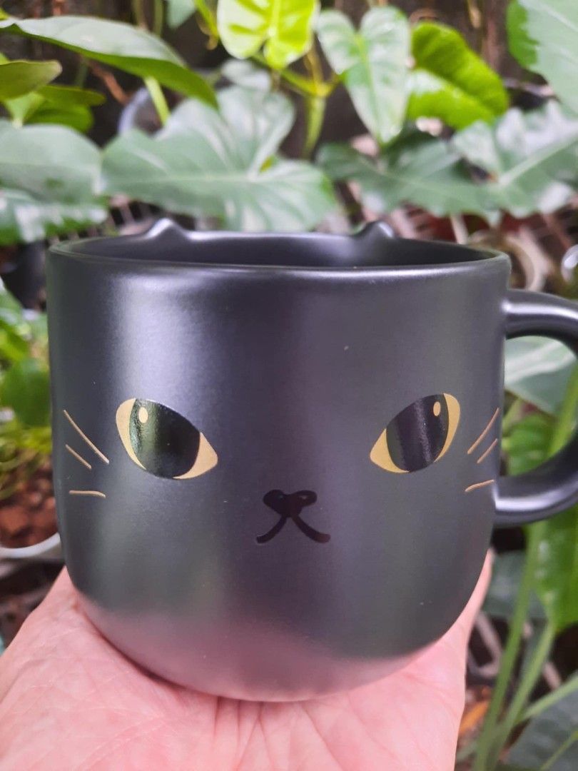 Starbucks Black Cat Mug (Category: Coffee & Tea Tableware) located in Quezon City. Submitted by anna.anna8 (Listing ID 1420517489, Image 1). Description: - Starbucks black cat mug - Features a unique cat face design - new.