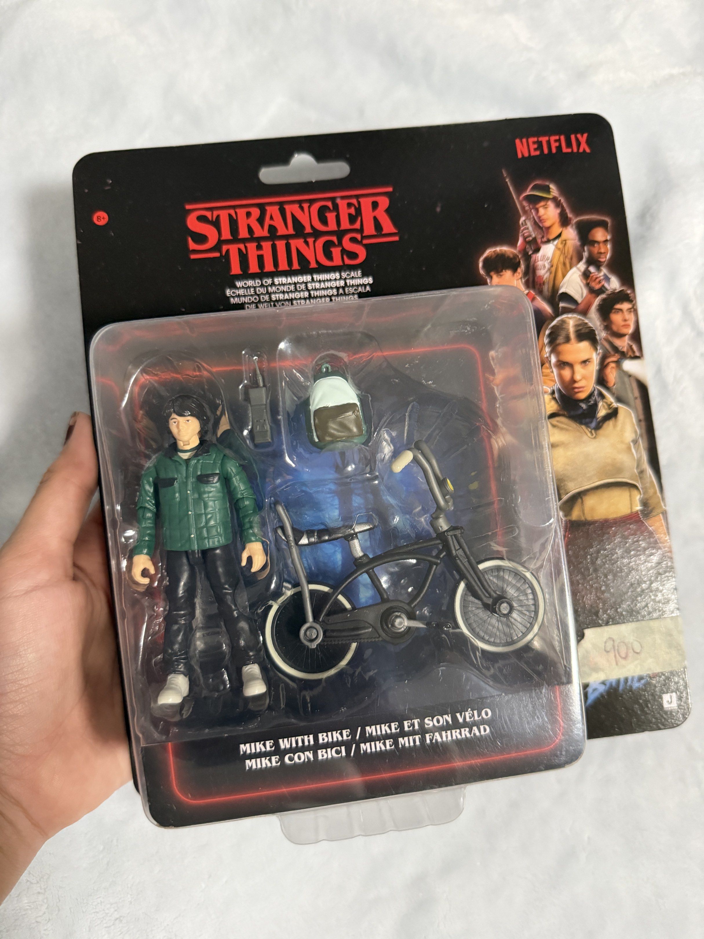 Stranger Things Mike with Bike Action Figure (Category: Figurines & Statues) located in Manila. Submitted by justella0429 (Listing ID 1420461601, Image 1). Description: - Mike Wheeler action figure with his bike - Includes accessories - Features the Netflix logo on the packaging - Box text in English, French, and German - Perfect for Stranger Things collectors.