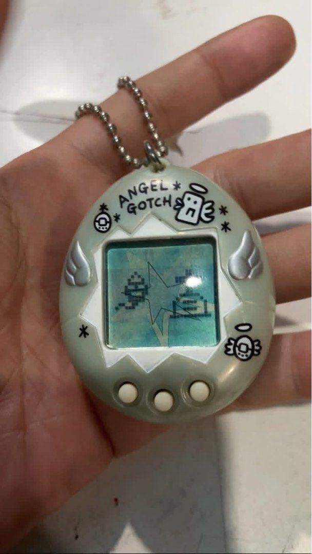 TAMAGOTCHI Bandai - Virtual Pets Angel Gotchi, HK / Hello Kitty, SANRIO, 1996, w/ markings all tested & working (Category: Interactive Toys) located in Marikina City. Submitted by anikanik. (Listing ID 1420493437, Image 2). Description: TAMAGOTCHI Bandai - Virtual Pets Angel Gotchi, HK / Hello Kitty, SANRIO, 1996, w/ markings all tested & working WYSIWYG 1250 each, all 3 for 3000.