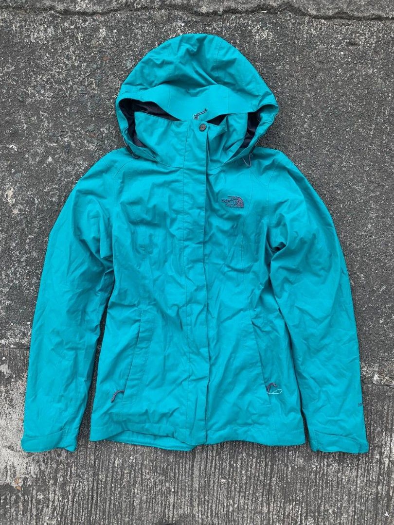 The North Face Jacket (Category: Coats, Jackets and Outerwear) located in Manila. Submitted by thrift2something (Listing ID 1420373339, Image 1). Description: - Teal The North Face jacket - Features a hood and zipper closure - Two front pockets - North Face logo on the chest - Made of lightweight material.