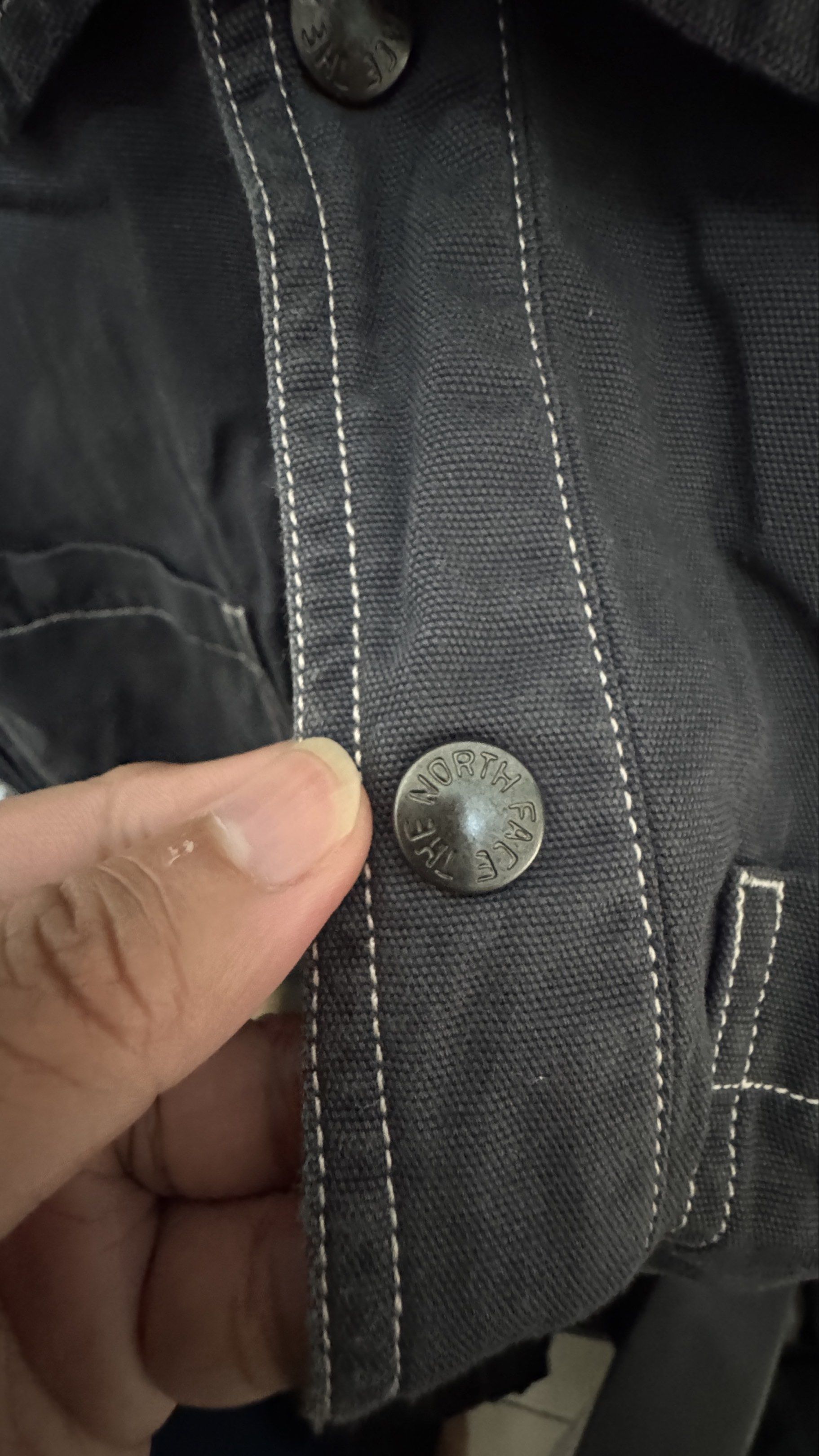 The North Face Jacket XL (Category: Coats, Jackets and Outerwear) located in Manila. Submitted by offthehype (Listing ID 1420428734, Image 3). Description: - The North Face jacket - Color: Dark Grey - Size: XL/105 - Button-up front - Two front pockets - White stitching details - Elastic cuffs - The North Face logo (front and back) - Thick denim like fabric Price is negotiable Good for overshirt or layering.