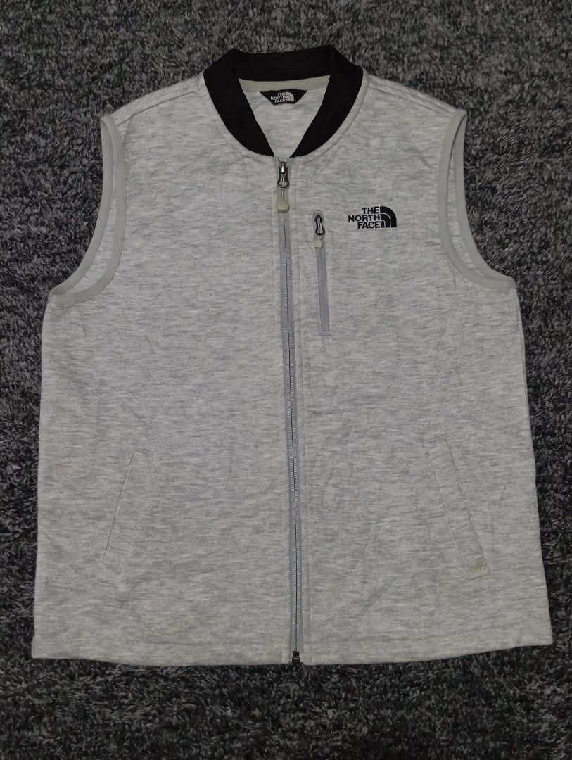 The North Face Vest (Category: Vests) located in Manila. Submitted by brugodoy (Listing ID 1420514773, Image 2). Description: - The North Face vest in gray - Features: - Full zip closure - Stand-up collar - Small chest pocket - The North Face logo on chest and back - Perfect for layering.