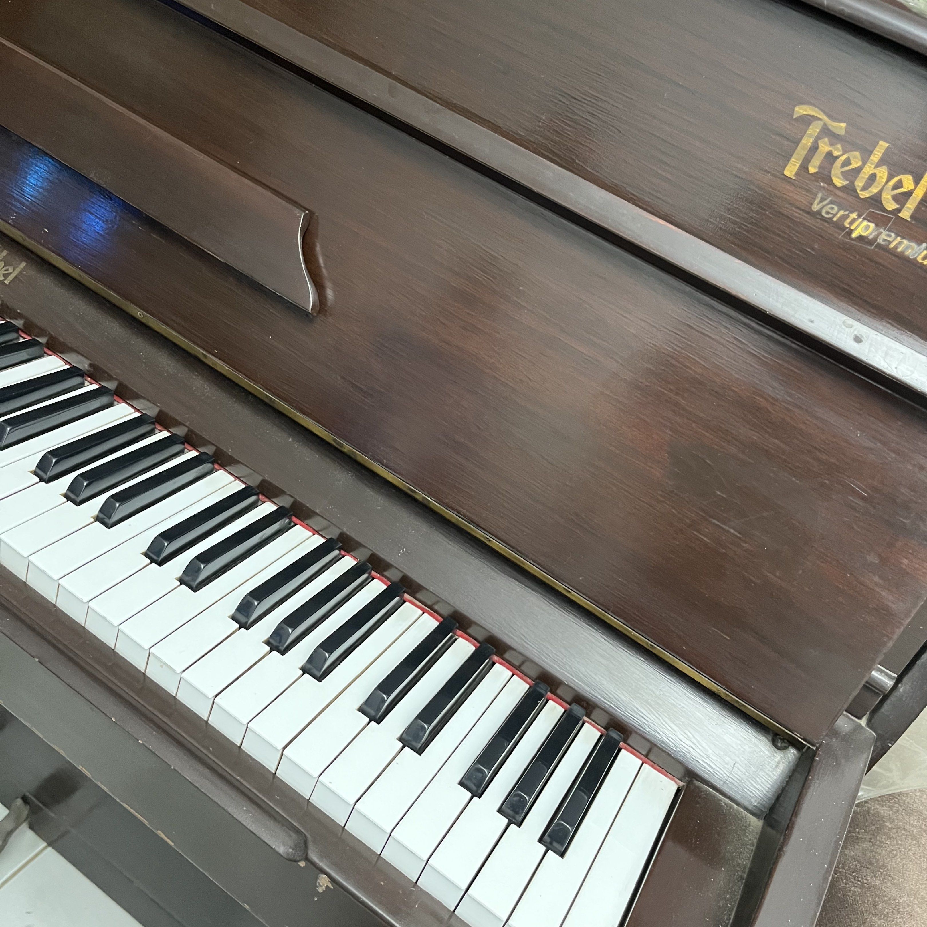 Trebel Vertipremium Piano (Category: Musical Instruments) located in Batangas. Submitted by yshachic_ (Listing ID 1420467455, Image 3). Description: - Trebel Vertipremium upright piano - Elegant dark brown finish - Full keyboard with white and black keys - Includes two pedals - Features the Trebel logo - Well-maintained conditioning Negotiable. Dm if interested. 📍Batangas.
