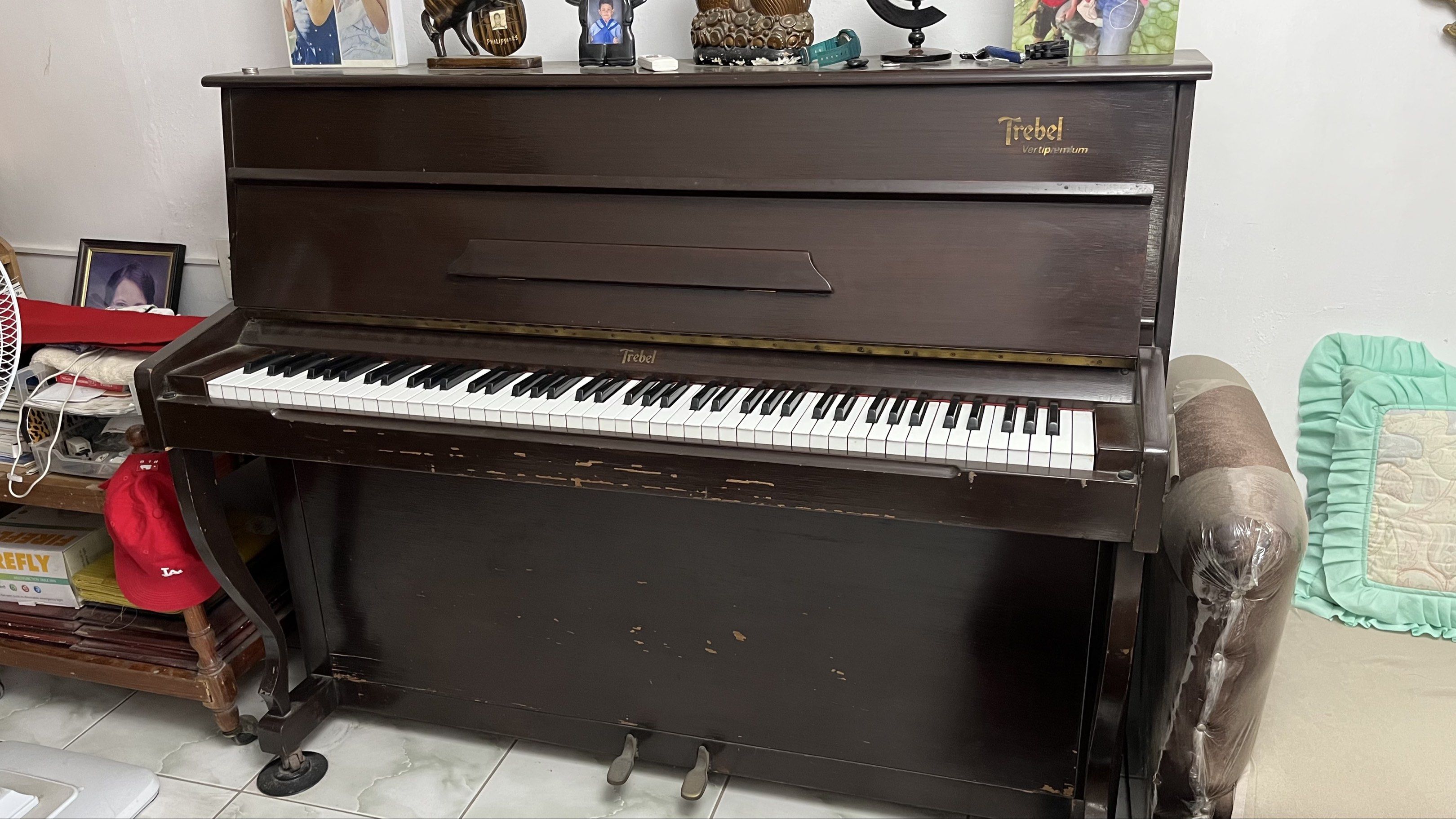Trebel Vertipremium Piano (Category: Musical Instruments) located in Batangas. Submitted by yshachic_ (Listing ID 1420467455, Image 2). Description: - Trebel Vertipremium upright piano - Elegant dark brown finish - Full keyboard with white and black keys - Includes two pedals - Features the Trebel logo - Well-maintained conditioning Negotiable. Dm if interested. 📍Batangas.