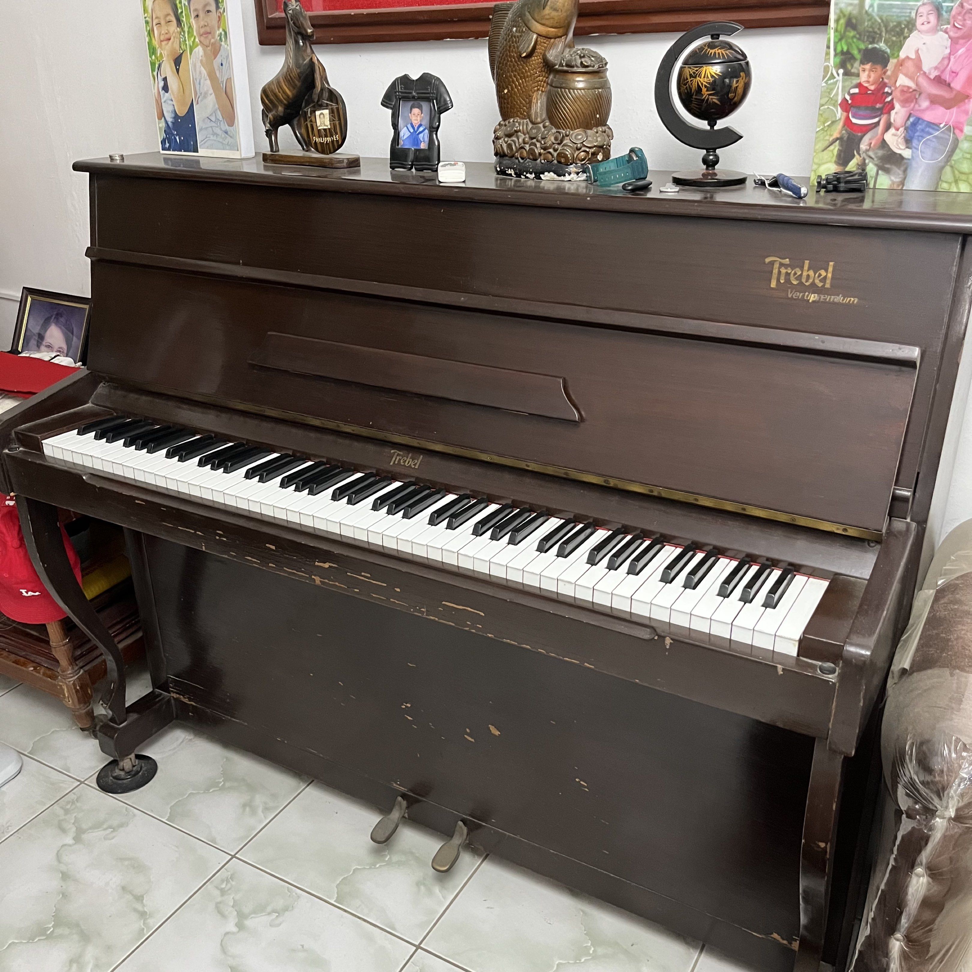 Trebel Vertipremium Piano (Category: Musical Instruments) located in Batangas. Submitted by yshachic_ (Listing ID 1420467455, Image 1). Description: - Trebel Vertipremium upright piano - Elegant dark brown finish - Full keyboard with white and black keys - Includes two pedals - Features the Trebel logo - Well-maintained conditioning Negotiable. Dm if interested. 📍Batangas.
