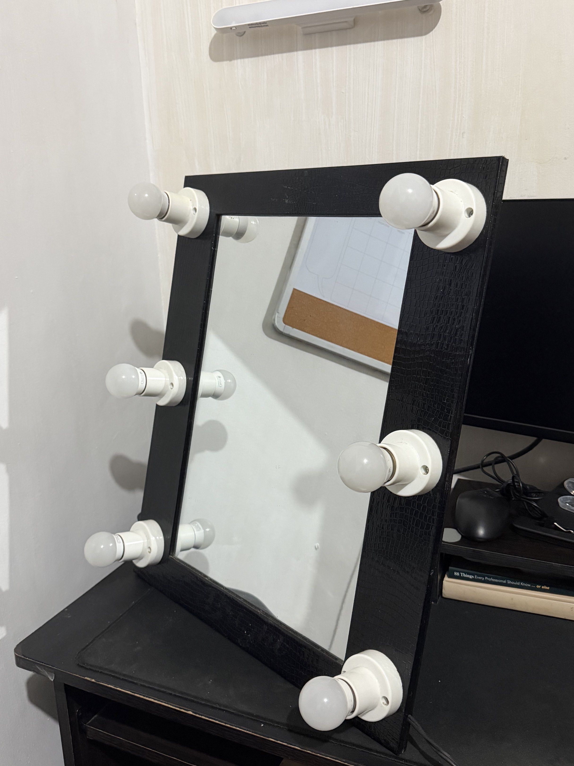 Vanity Mirror with Lights (Category: Mirrors) located in Makati City. Submitted by brijette_ (Listing ID 1420372037, Image 1). Description: - Vanity mirror with built-in lights - Black frame - Stand for desk - Includes power cord - Comes with a black carrying bag.