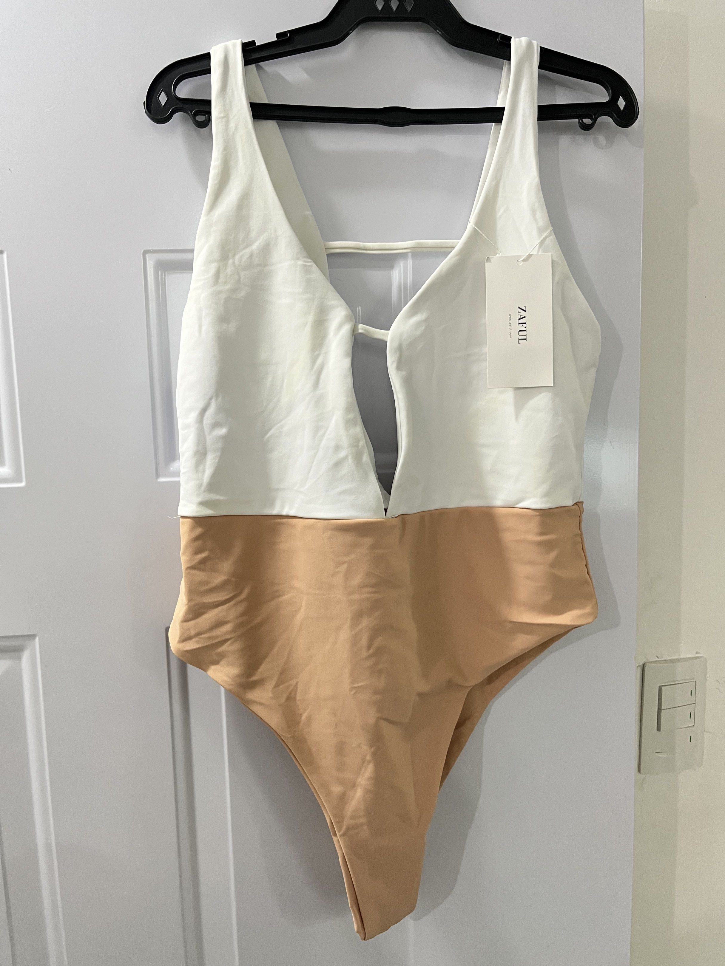 ZAFUL Swimsuit - XL (non-padded) (Category: Bikinis & Swimsuits) located in General Trias. Submitted by jc_3096 (Listing ID 1420525019, Image 1). Description: - ZAFUL swimsuit (NO pads) - Size: XL but also fit to Large - Colors: White and tan - Features a plunging neckline - Unique back detail - Perfect for beach or pool days.
