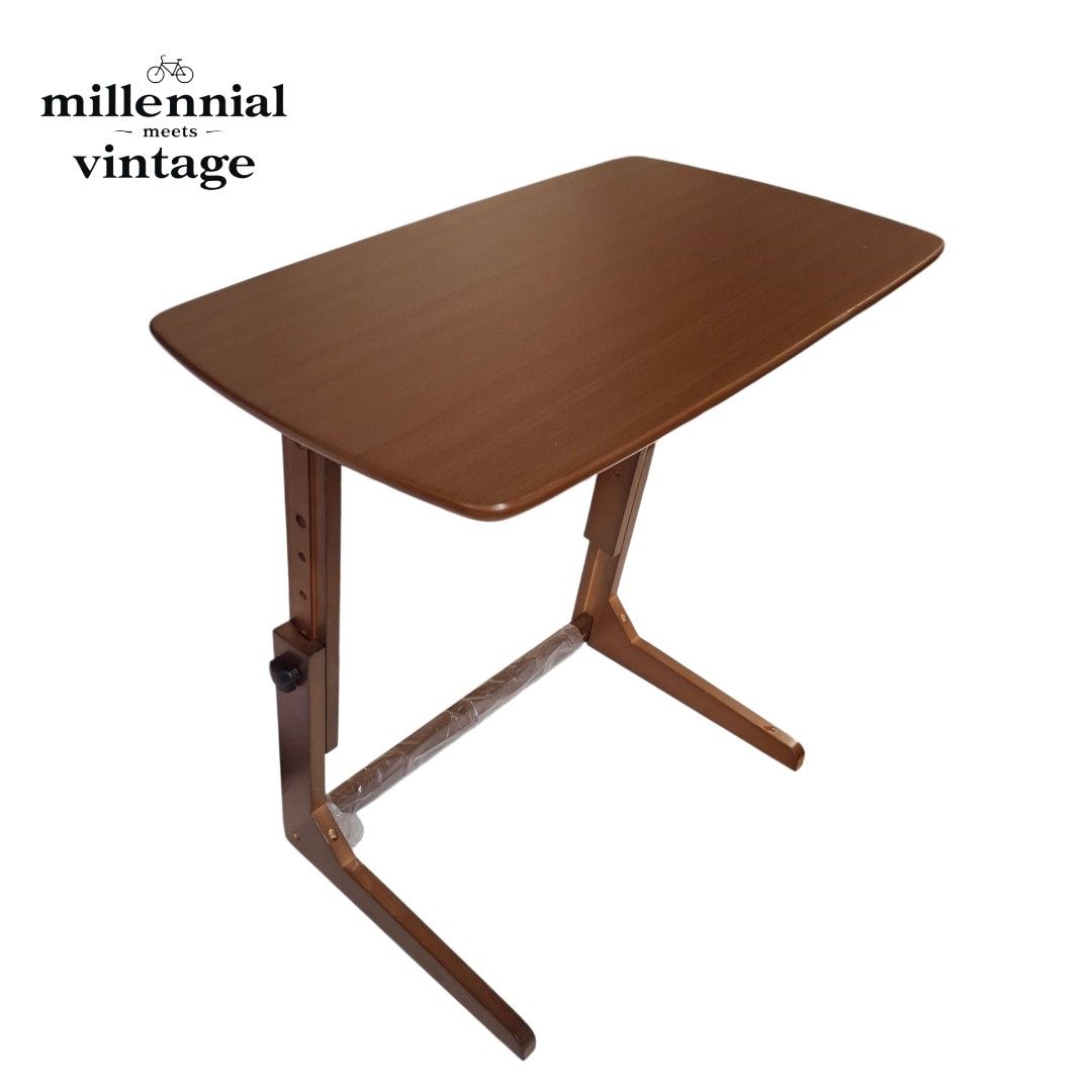 Adjustable wooden desk laptop table study desk side table (Category: Tables & Sets) located in Dasmarinas. Submitted by millennialmeetsvintage (Listing ID 1420677032, Image 2). Description: Upgrade your home with this versatile, height-adjustable wooden side table. Its smart C-shaped design slides seamlessly under your sofa or bed, making it perfect for small spaces. ⚜️Versatile use: Adjusts easily for typing, reading, or dining. ⚜️Smart design: 