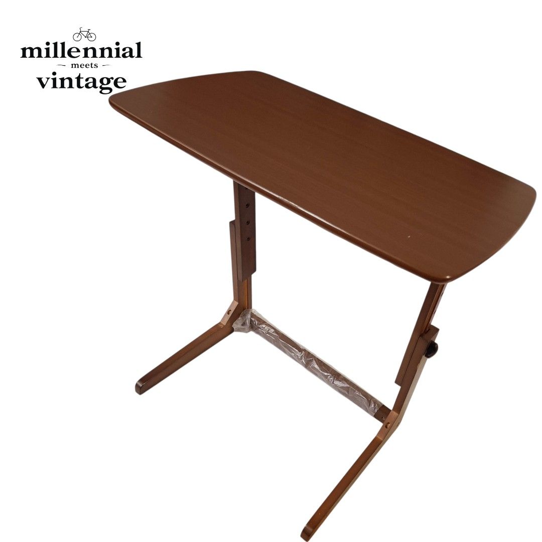 Adjustable wooden desk laptop table study desk side table (Category: Tables & Sets) located in Dasmarinas. Submitted by millennialmeetsvintage (Listing ID 1420677032, Image 3). Description: Upgrade your home with this versatile, height-adjustable wooden side table. Its smart C-shaped design slides seamlessly under your sofa or bed, making it perfect for small spaces. ⚜️Versatile use: Adjusts easily for typing, reading, or dining. ⚜️Smart design: 