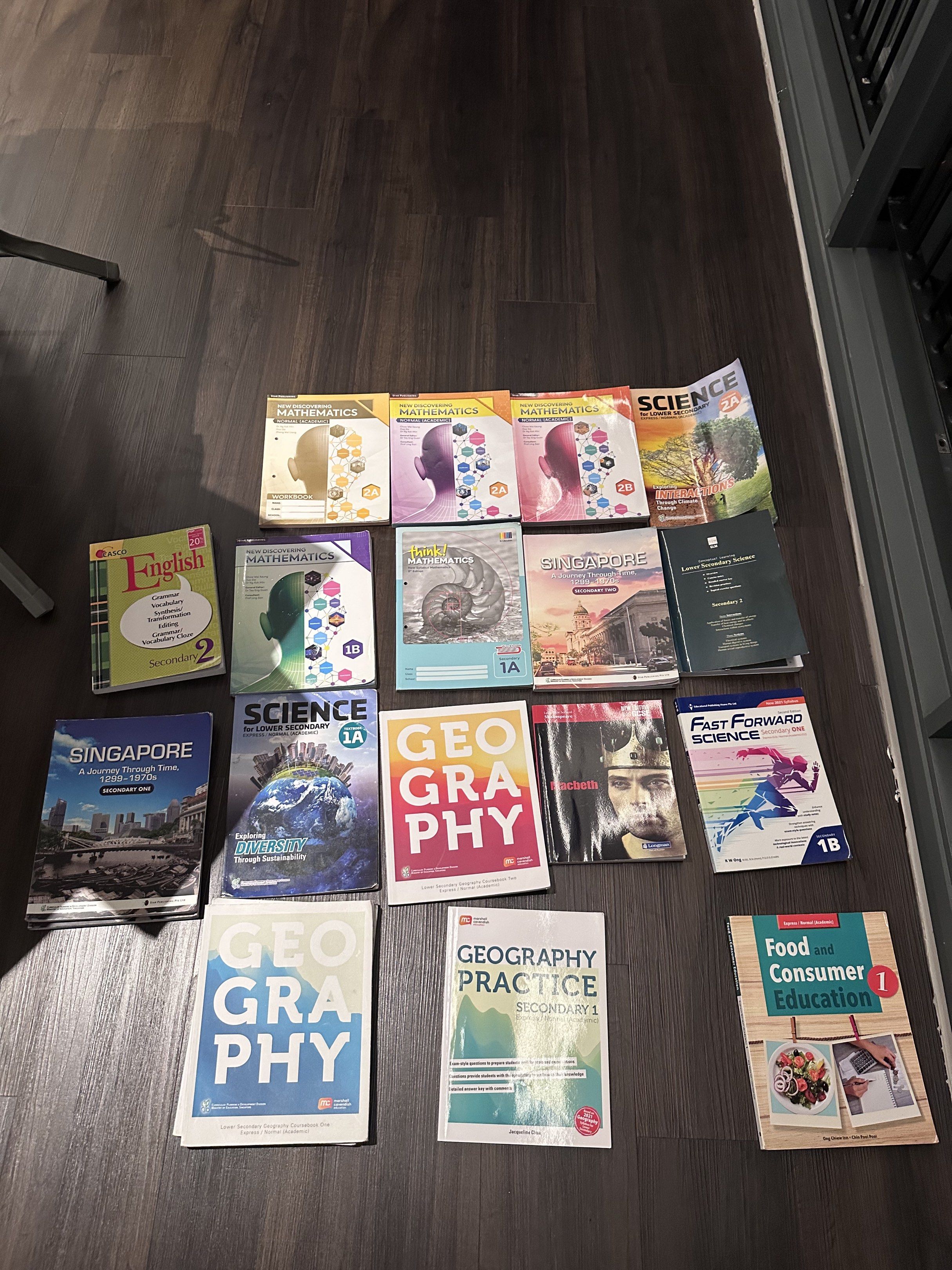 Assorted textbooks and workbooks for secondary students.