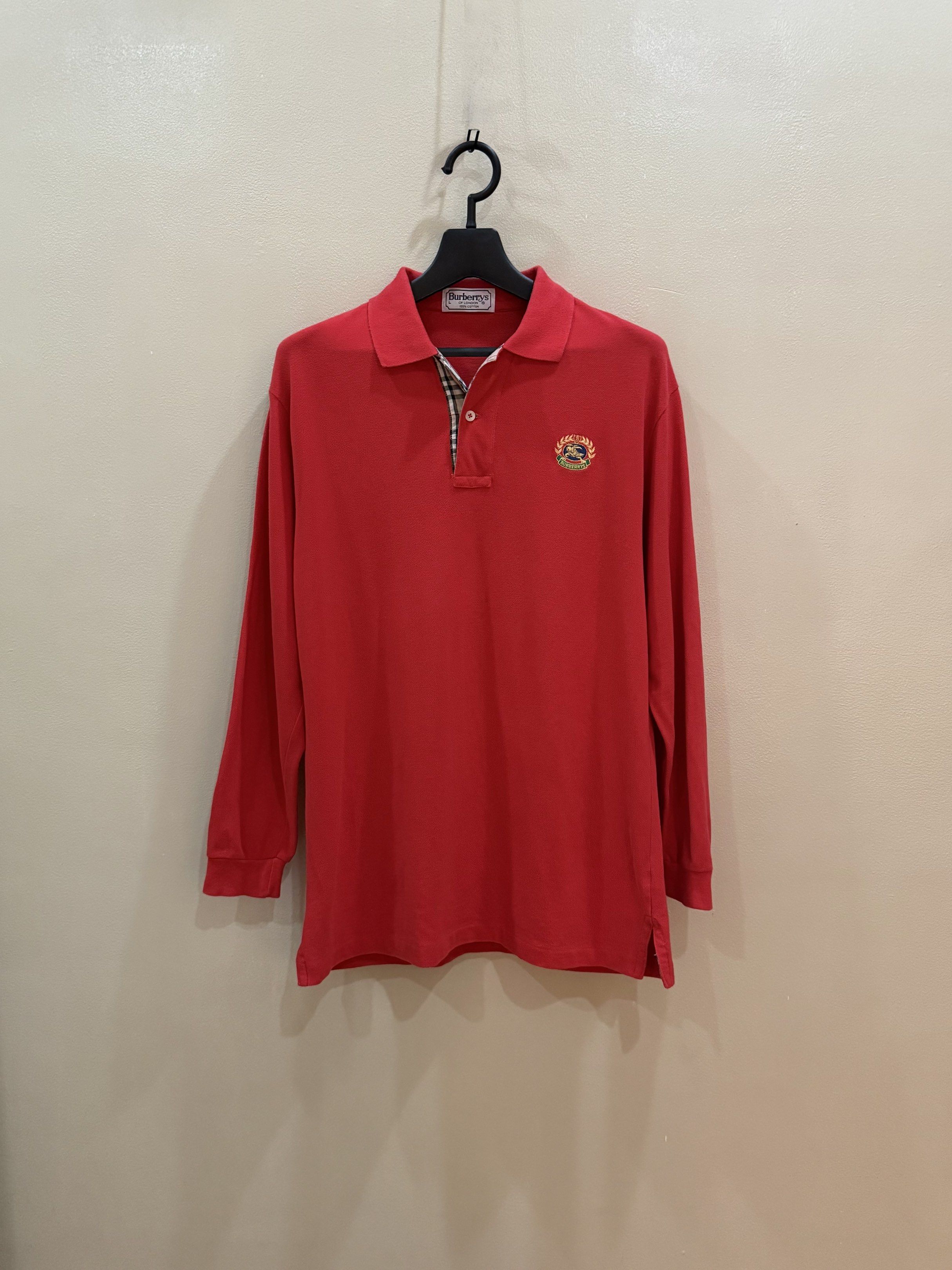 Burberrys Vintage Red Long sleeves Jacket (Category: Coats, Jackets and Outerwear) located in Quezon City. Submitted by nyc1900 (Listing ID 1420712681, Image 1). Description: Vintage Burberrys long-sleeved polo shirt. Never been used. Length: 30” Chest: 22” Shoulder: 20” Sleeve: 23” - Eye-catching red color - Size: L - Features iconic Burberry check detailing on collar and cuffs - A classic and stylish addition to any wardrobe NEGOTIABLE 🫡 DM fo