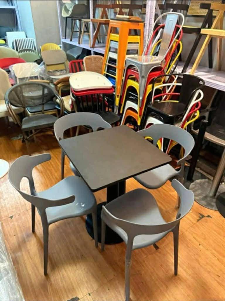Cafe Table and Chairs Set (Category: Tables & Sets) located in Manila. Submitted by mry_rfl (Listing ID 1420737738, Image 2). Description: - Stylish cafe table and chairs set - Ideal for small spaces and cafes - Includes a table and four chairs - Available in various colors and table shapes - Chairs feature a unique and comfortable design - Durable and easy to clean - Creates a cozy dining or seating area.