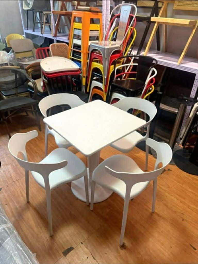 Cafe Table and Chairs Set (Category: Tables & Sets) located in Manila. Submitted by mry_rfl (Listing ID 1420737738, Image 3). Description: - Stylish cafe table and chairs set - Ideal for small spaces and cafes - Includes a table and four chairs - Available in various colors and table shapes - Chairs feature a unique and comfortable design - Durable and easy to clean - Creates a cozy dining or seating area.