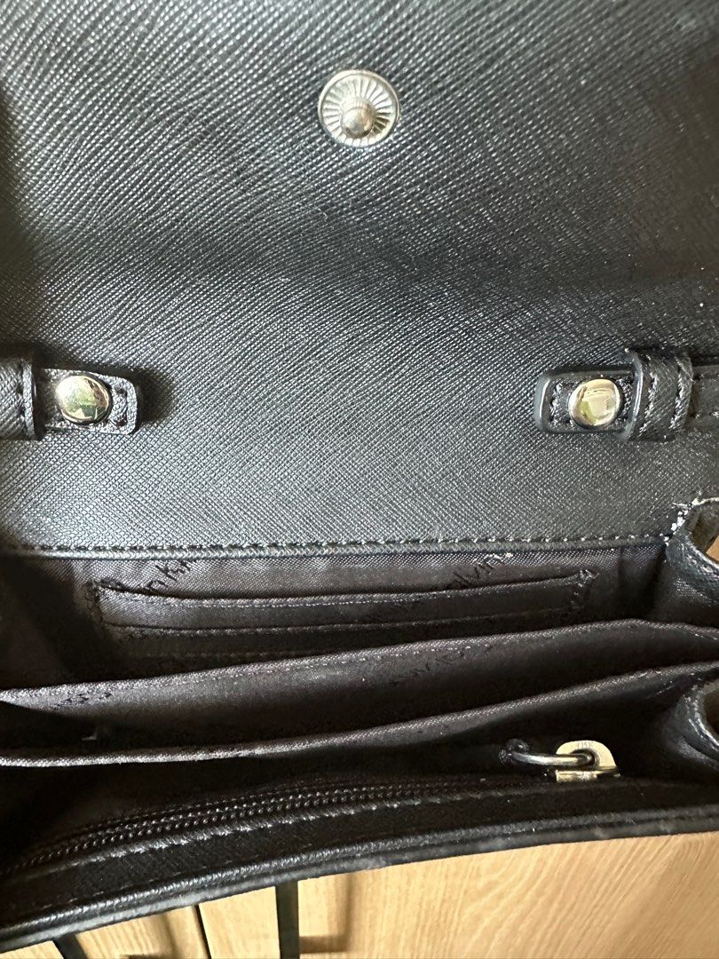 Calvin Klein Black Crossbody Bag (Category: Cross-body Bags) located in Quezon City. Submitted by sofieegee (Listing ID 1420651042, Image 3). Description: - Black Calvin Klein crossbody bag - Silver chain strap - Flap closure with magnetic snap - Interior: card slots and zippered pocket - Textured finish - Calvin Klein logo on front.