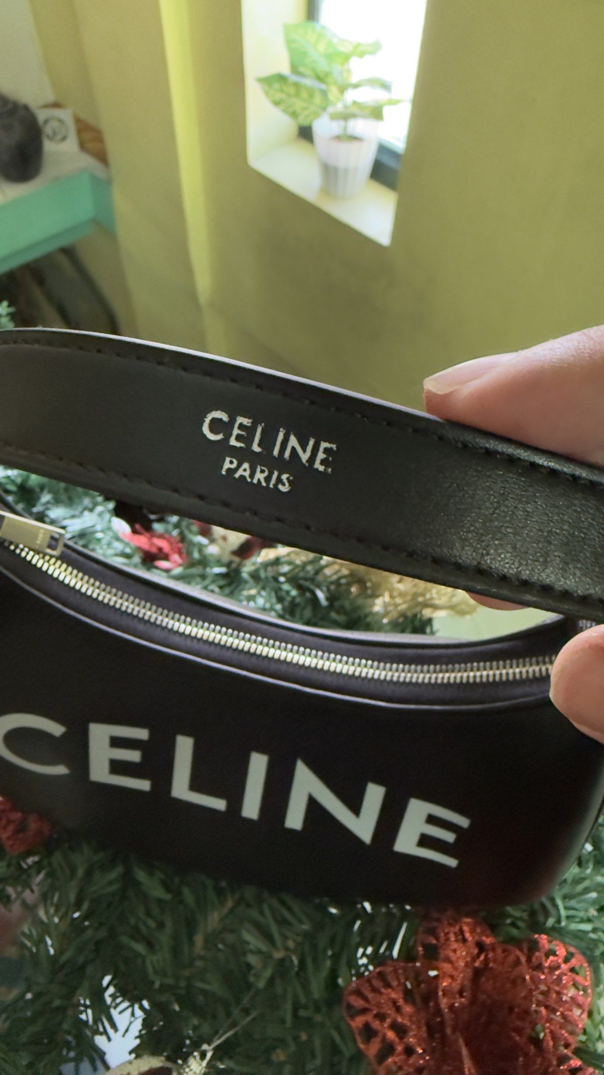Celine Ava Bag (Category: Luxury Bags & Wallets) located in Cabuyao City. Submitted by gerliecloset20243 (Listing ID 1420659142, Image 2). Description: - Celine Ava bag (Full Soft Leather) - Black color - Curved shape - White Celine logo - Zipper closure - Detachable strap - Celine Paris logo on zipper and strap - Includes dust bag only -Shipping Fee not included -Japan sourced -Like new condition no flaws or damage. Price can be negotiated for s
