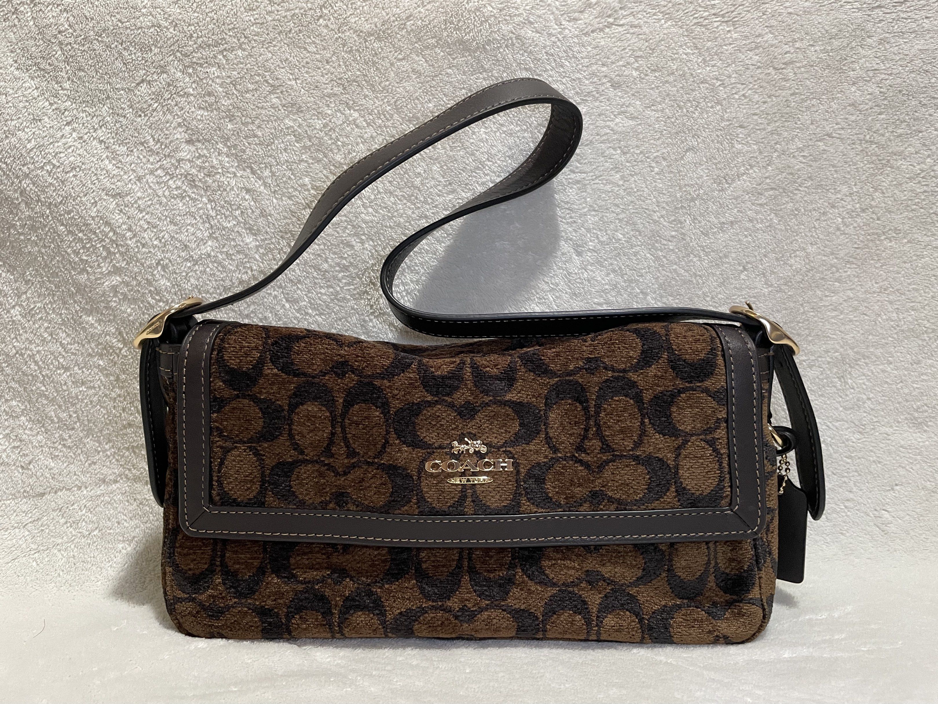 Coach Signature Etta Chenille - Truffle Brown (Category: Luxury Bags & Wallets) located in Mandaluyong City. Submitted by wysluxe (Listing ID 1420593436, Image 1). Description: - Original Coach shoulder bag - Brown signature pattern - Top handle and detachable shoulder strap - Flap closure with Coach logo - Interior: zippered pocket and Coach tag - 27x13x7cm.