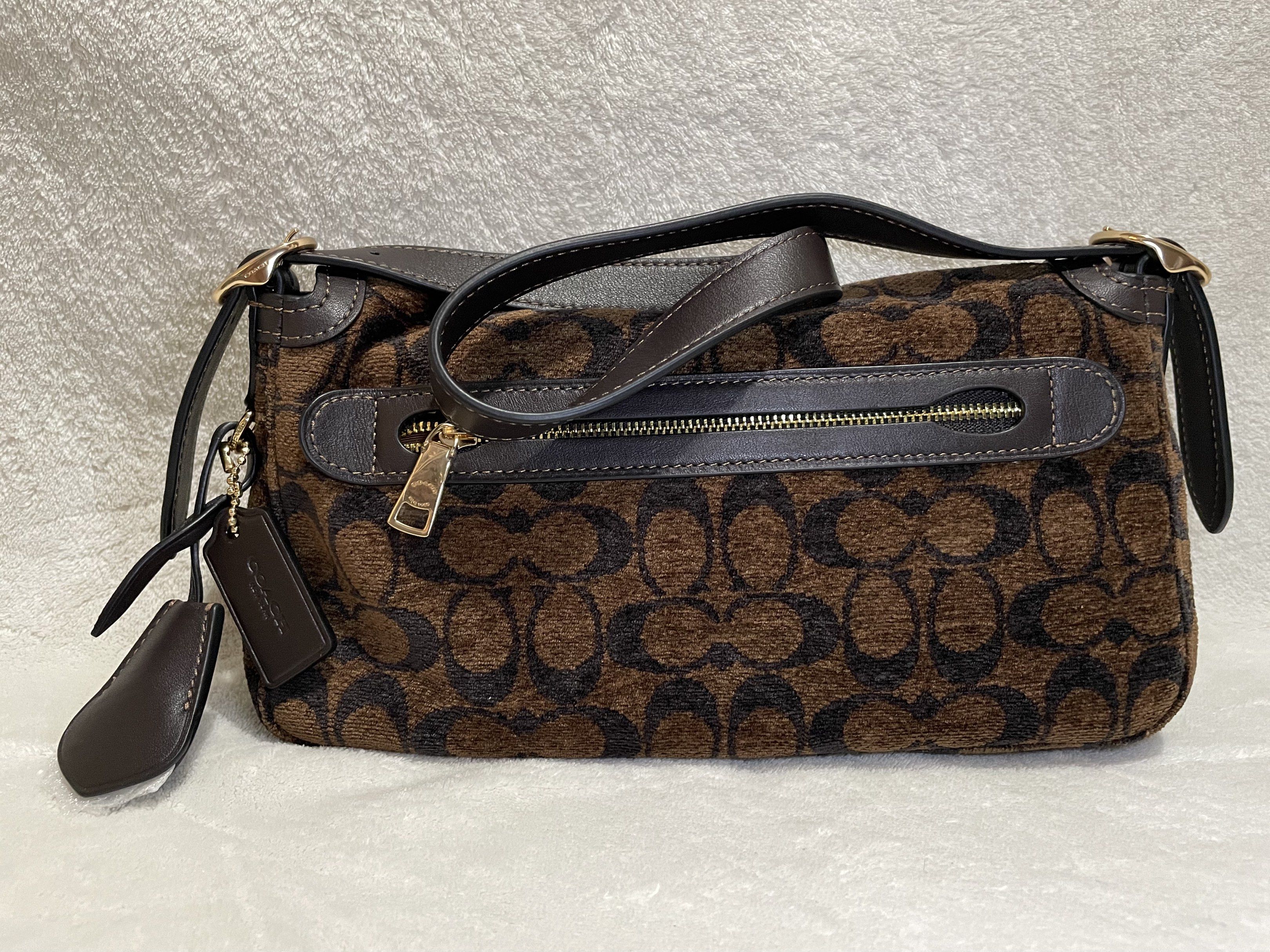 Coach Signature Etta Chenille - Truffle Brown (Category: Luxury Bags & Wallets) located in Mandaluyong City. Submitted by wysluxe (Listing ID 1420593436, Image 2). Description: - Original Coach shoulder bag - Brown signature pattern - Top handle and detachable shoulder strap - Flap closure with Coach logo - Interior: zippered pocket and Coach tag - 27x13x7cm.