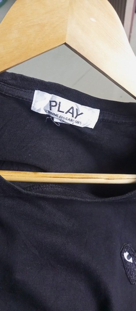 Comme des Garcons Play Black T-shirt (Category: Shirts) located in Calamba. Submitted by ironjayy050812 (Listing ID 1420606416, Image 2). Description: excellent condition issue 1 pinhole unnoticable nasa pic dimes 19-25 - Black Comme des Garcons Play T-shirt - Features the iconic heart logo - Crew neck and short sleeves - Brand tag visible.