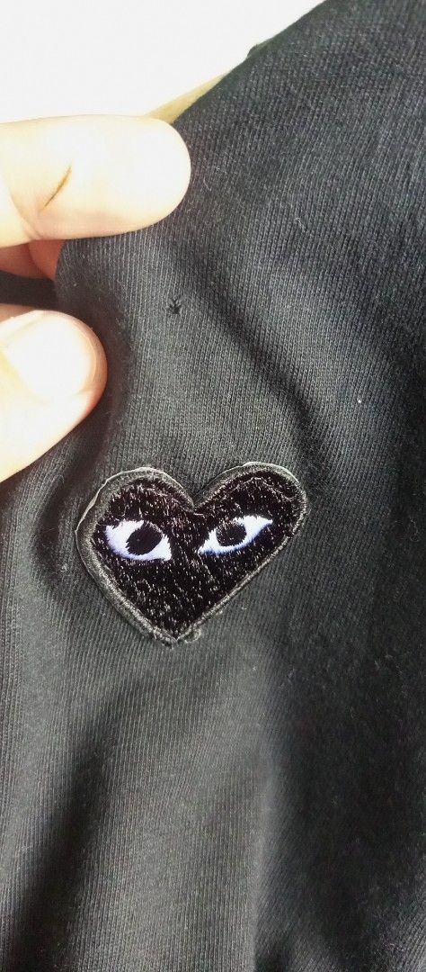 Comme des Garcons Play Black T-shirt (Category: Shirts) located in Calamba. Submitted by ironjayy050812 (Listing ID 1420606416, Image 3). Description: excellent condition issue 1 pinhole unnoticable nasa pic dimes 19-25 - Black Comme des Garcons Play T-shirt - Features the iconic heart logo - Crew neck and short sleeves - Brand tag visible.
