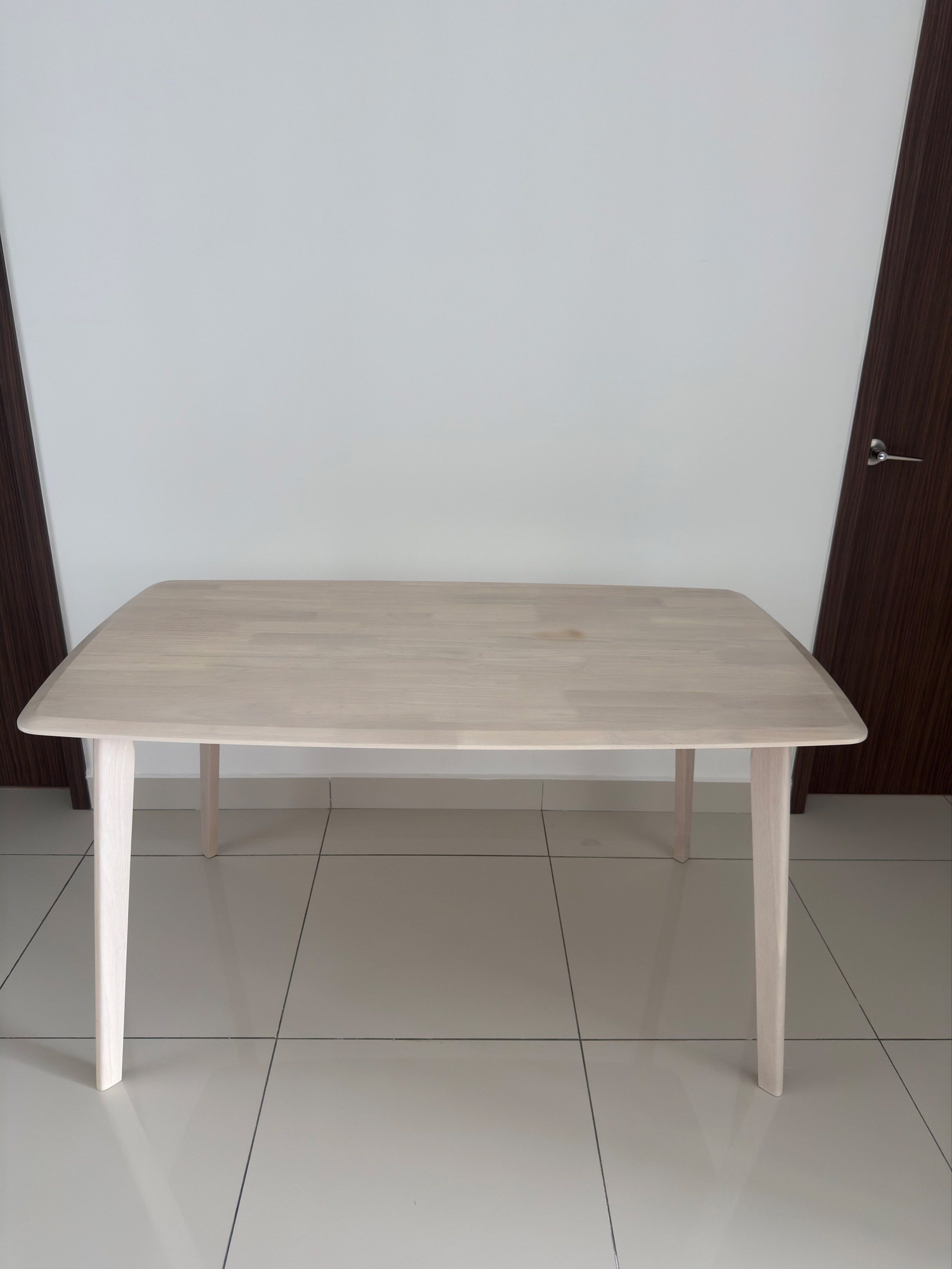 Dining table (Category: Tables & Sets) located in Ayer Baloi. Submitted by grace621 (Listing ID 1420623586, Image 1). Description: L 140cm, W 80cm, H 74cm - Stylish wooden dining table - Light wood finish - Rectangular top with rounded corners - Four sturdy legs - Small stain on tabletop - Ideal for small dining areas or as a desk.