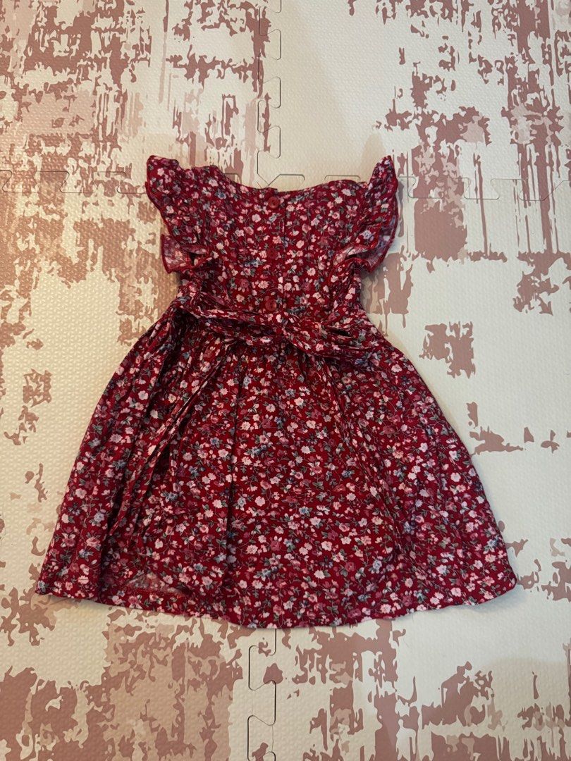 Floral Dress with Flutter Sleeves (Category: Dresses) located in Calamba. Submitted by xhrnn (Listing ID 1420650778, Image 2). Description: Dress features a vibrant floral pattern in shades of red, pink, and blue. It has flutter sleeves and a fitted bodice that flows into a flared skirt. The dress includes a matching tie-waist for a customizable fit. Perfect for casual outings or special occasions..