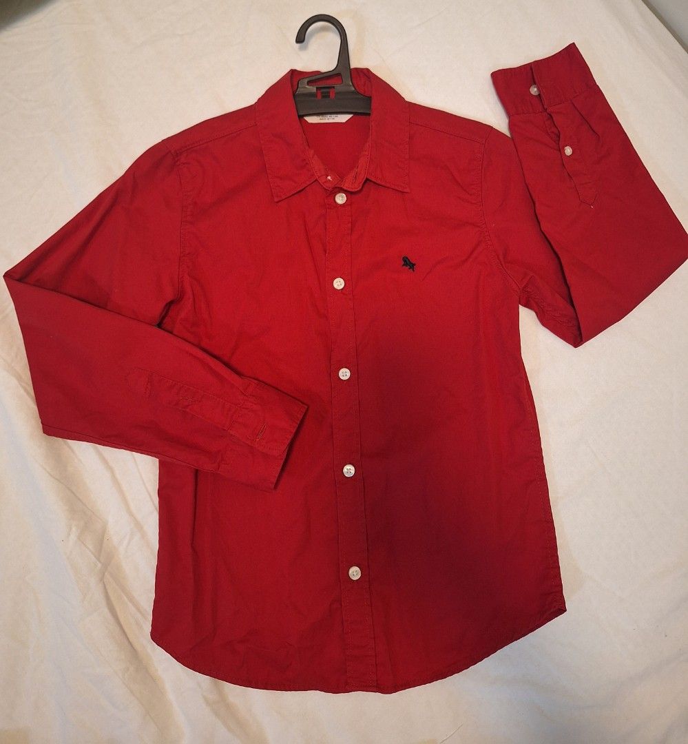 H&M Red Long Sleeve Shirt (Category: Babies & Kids Fashion) located in Antipolo. Submitted by flutterby41319 (Listing ID 1420662726, Image 1). Description: - H&M red long sleeve shirt - Button-down front - Small embroidered detail on chest - Classic collar - Buttoned cuffs - Size: EUR 128, US 7, CA 7-8A, CN 130/64, MX 7-8A, AUS 8, UK 7-8Y.
