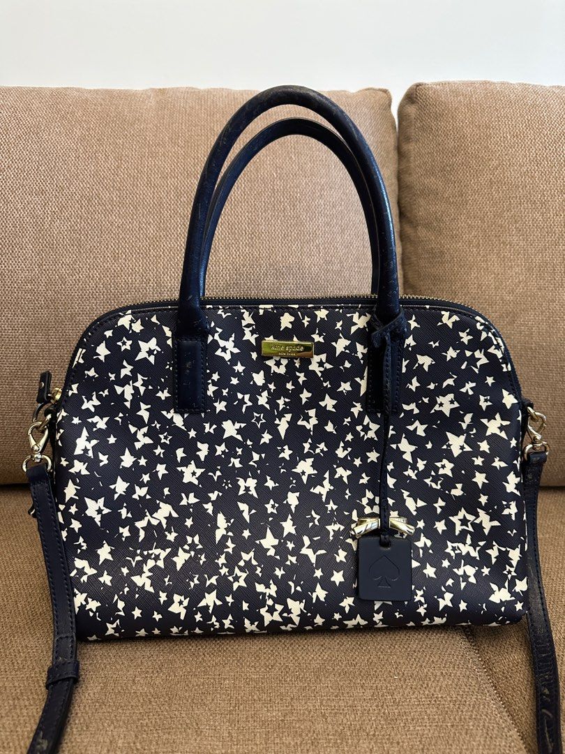 Kate Spade Star Print Satchel (Category: Luxury Bags & Wallets) located in Quezon City. Submitted by sofieegee (Listing ID 1420651482, Image 1). Description: - Kate Spade satchel - Navy and white star print - Includes Kate Spade logo charm - Interior: zip pocket - Lined with navy fabric with Kate Spade New York logo - Zip closure - has flaws see photos.