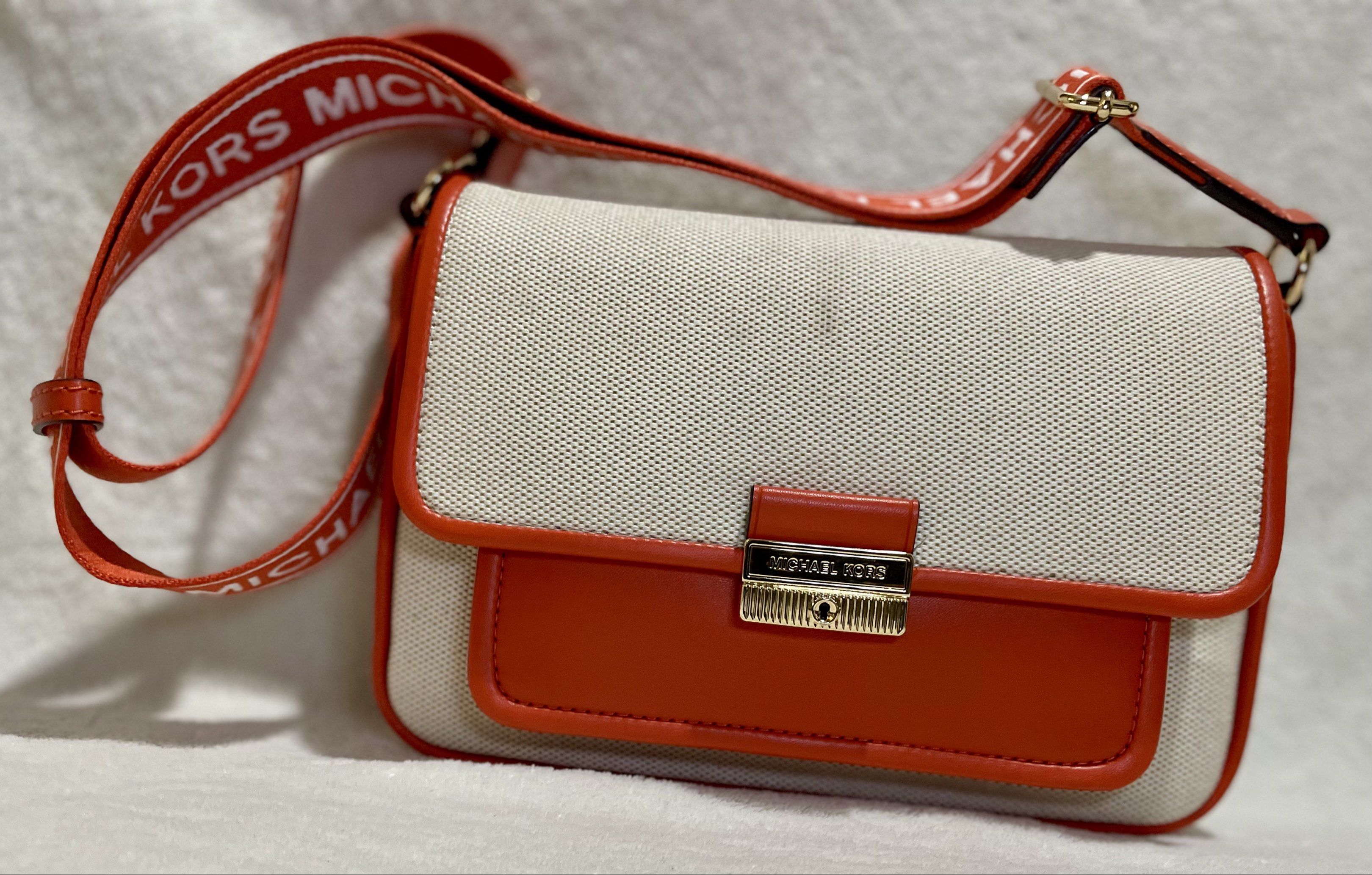Michael Kors Bradshaw Pocket Messenger bag (Category: Luxury Bags & Wallets) located in Mandaluyong City. Submitted by wysluxe (Listing ID 1420596176, Image 3). Description: - Original Michael Kors crossbody bag - Red Clay White - Canvas body with orange leather accents - Matching strap with Michael Kors logo - Front pocket - Main compartment with zipper closure - Includes care card - 24x16x6cm.