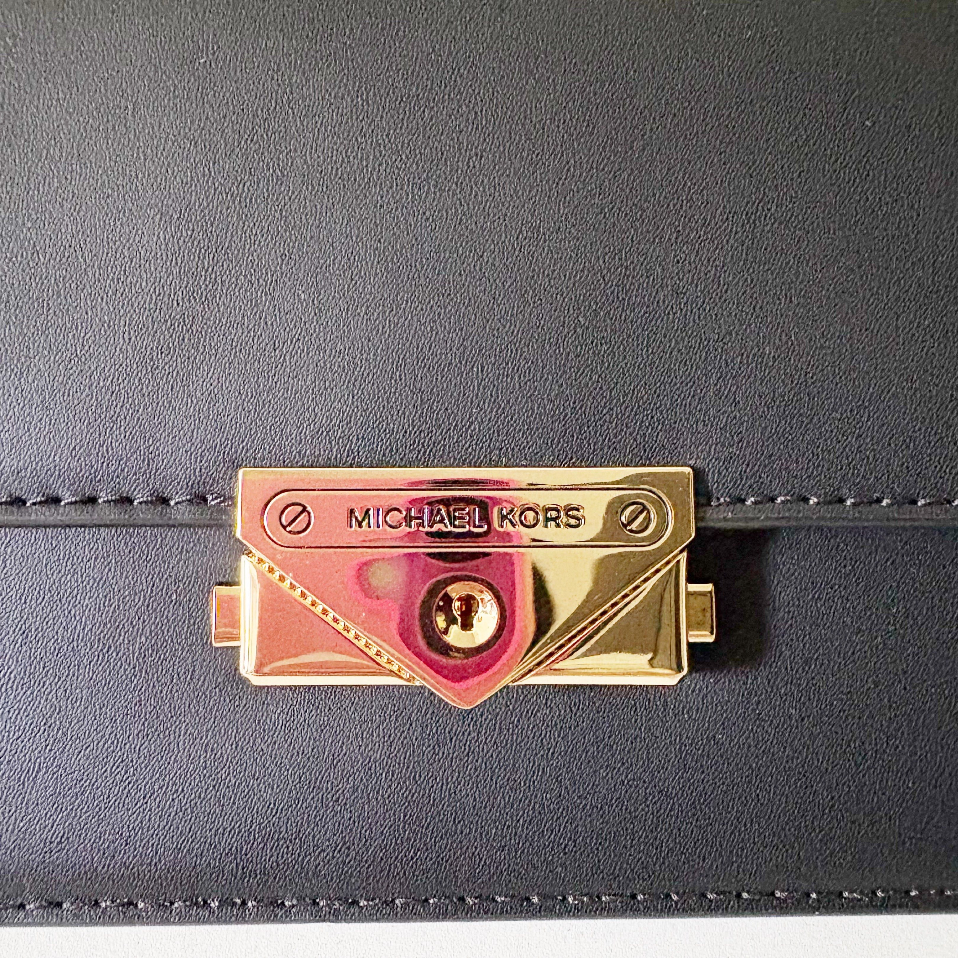 Michael Kors Cece Chain Clutch Bag (Category: Luxury Bags & Wallets) located in Caloocan City. Submitted by _yownice (Listing ID 1420653900, Image 3). Description: Michael Kors Cece Chain Clutch Bag 100% original Onhand and ready to ship Actual photos and final price posted. Details: - Sleek black design - Gold-tone chain strap and hardware - Flap closure with Michael Kors logo - Detachable strap included - Interior with multiple compartments.