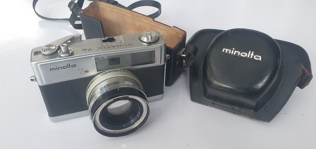 Minolta Hi-Matic 7s Camera with Case (Category: Cameras) located in Quezon City. Submitted by gars69 (Listing ID 1420563472, Image 3). Description: - Vintage Minolta -Matic 7s camera - Includes original black case - Comes with original black strap - Silver and black body Can be used to take down goliath due to its weight Pick up near sm novaliches - Film compartment visible in photos - Features a lens - Minolta logo on case.