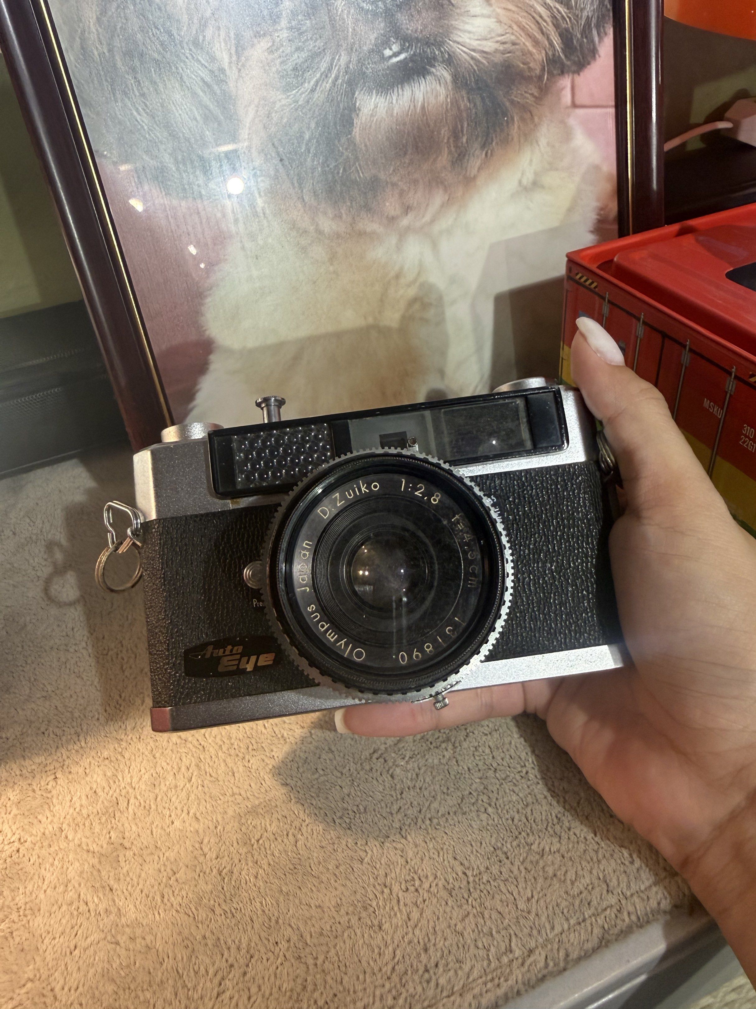 Olympus Auto Eye Camera (Category: Cameras) located in Manila. Submitted by dashanonuevo (Listing ID 1420589804, Image 2). Description: Released in 1960, this was a groundbreaking camera for its time. It was the first Japanese 35mm rangefinder to offer “shutter-priority” automatic exposure, meaning you pick the speed and the camera’s “Electric Eye” handles the rest. - Olympus Auto Eye camera - D.Zuiko 1:2.8 f=4.5cm lens - Includes lens cap - Silv