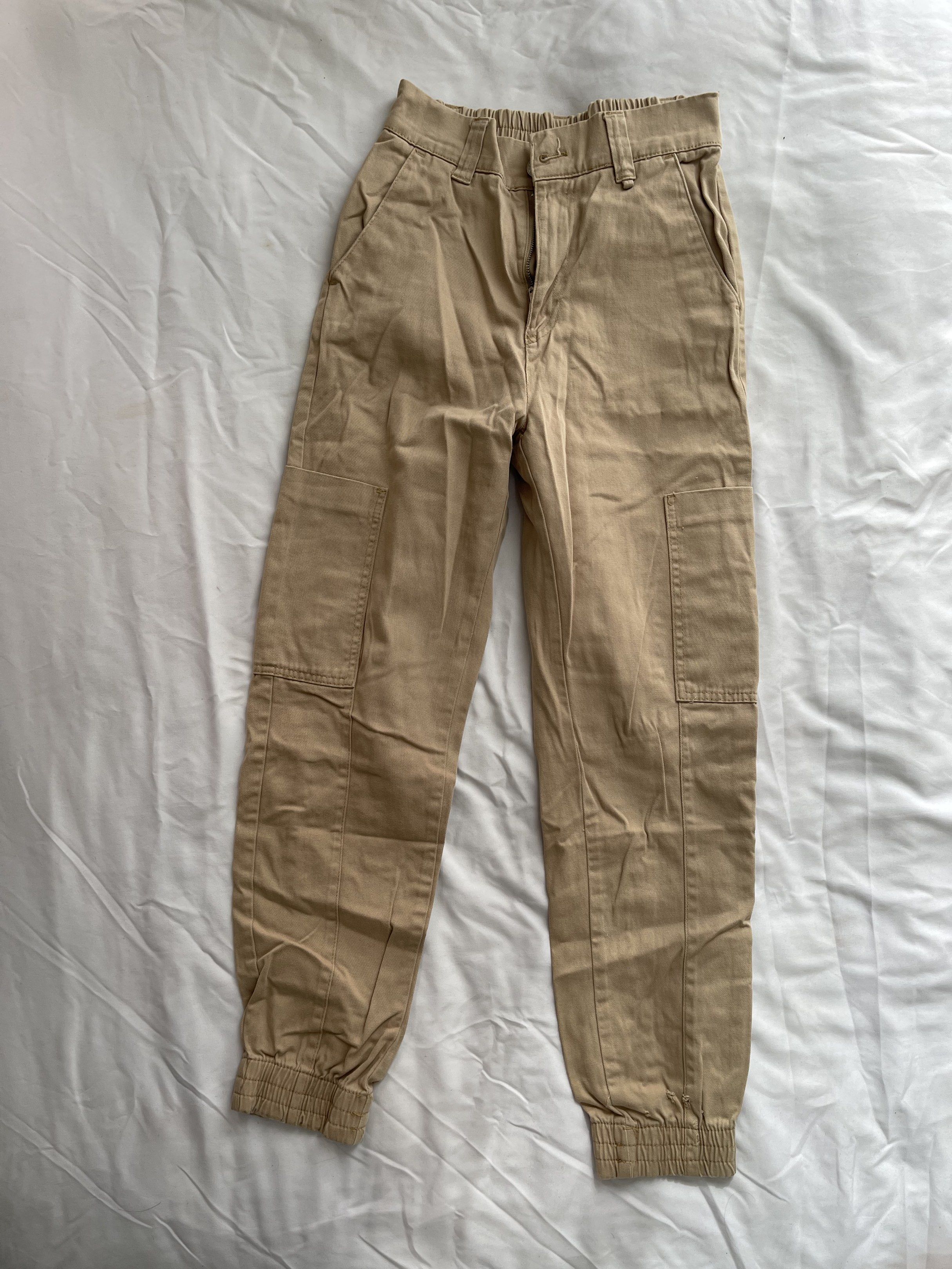 Pull&Bear Khaki Jogger Pants (Category: Joggers) located in Manila. Submitted by joyobaldo158861 (Listing ID 1420564129, Image 1). Description: - Pull&Bear jogger pants - Color: Khaki - Size: EU 36 / US 6 - Features: Elastic waistband, pockets - Condition: Minor tear on elastic cuff - Made in Turkey.