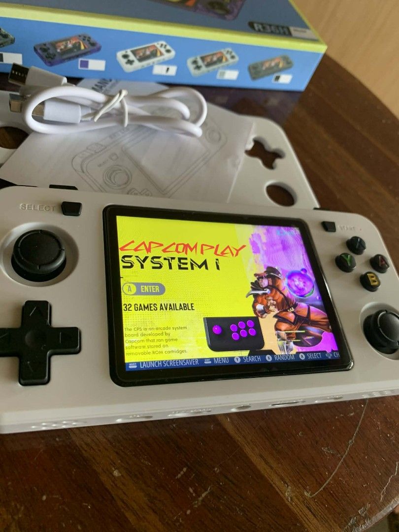 R36H Handheld Game Console (Category: Others) located in Mangaldan. Submitted by michelle_2004 (Listing ID 1420564411, Image 2). Description: R36H handheld game console comes with a variety of pre-installed games, including Nintendo Famicom, Capcom Play System I, Nintendo Gameboy Advance, Nintendo Gameboy Color, Sony Playstation, Nintendo Ultra 64, Sony PSP, and Multiple Arcade MAME 2003. It includes a charging cable and a manual. The console is 