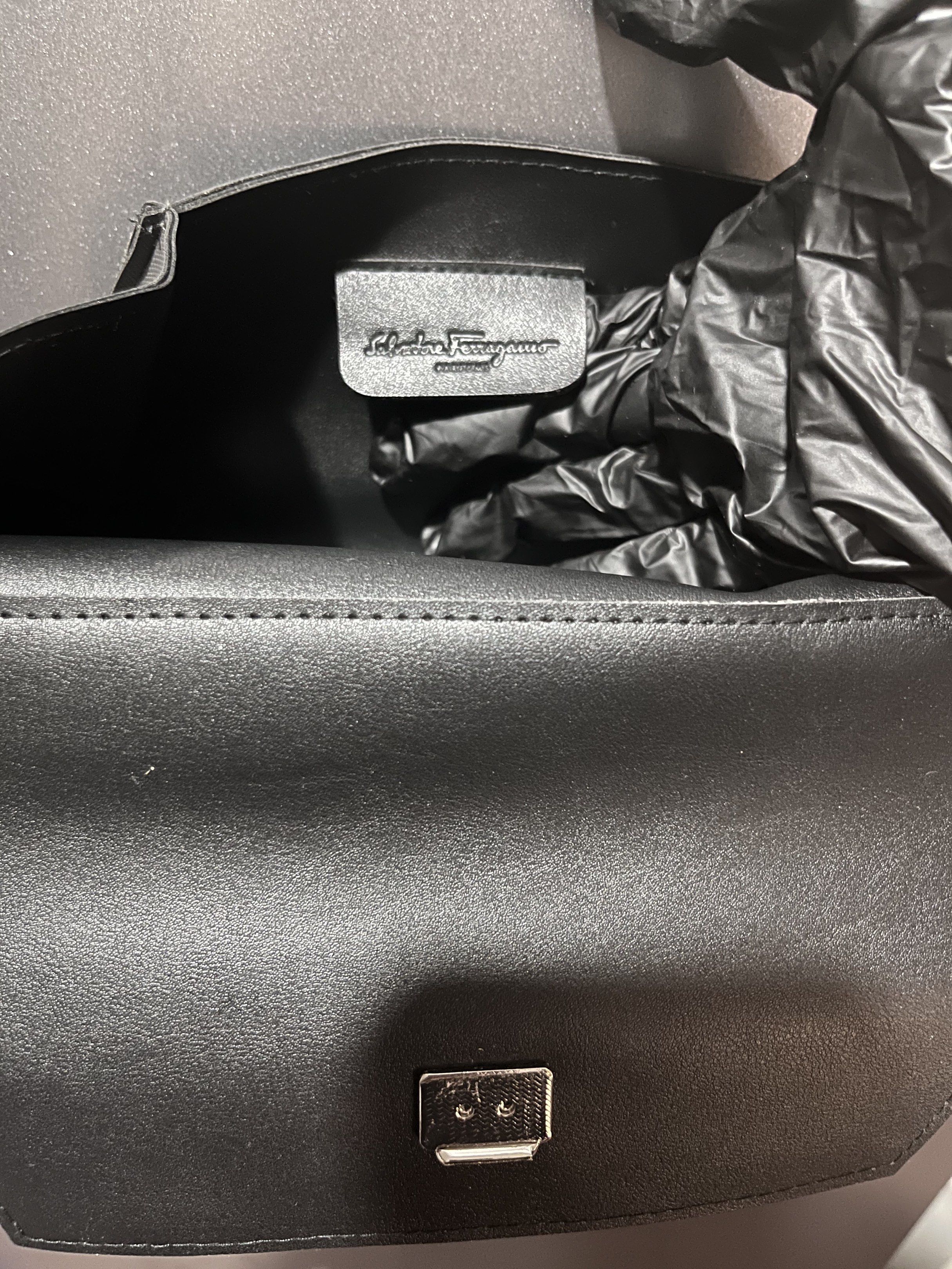Salvatore Ferragamo Clutch Pouch (Category: Luxury Bags & Wallets) located in Manila. Submitted by kathprima (Listing ID 1420576086, Image 2). Description: - Salvatore Ferragamo clutch in grey - Flap closure with silver-tone clasp - Features the brand's logo - Textured exterior - Single interior compartment.