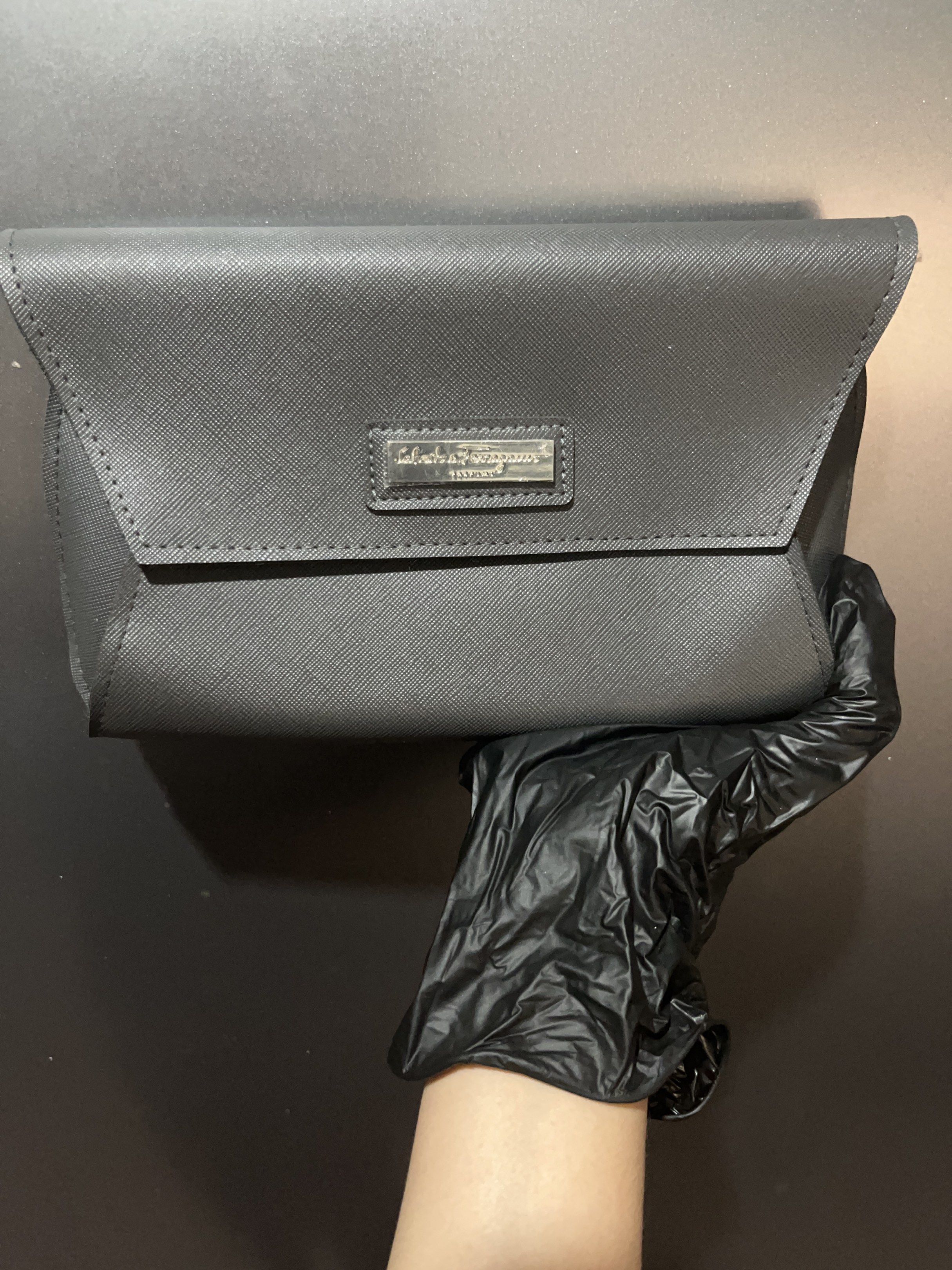 Salvatore Ferragamo Clutch Pouch (Category: Luxury Bags & Wallets) located in Manila. Submitted by kathprima (Listing ID 1420576086, Image 1). Description: - Salvatore Ferragamo clutch in grey - Flap closure with silver-tone clasp - Features the brand's logo - Textured exterior - Single interior compartment.