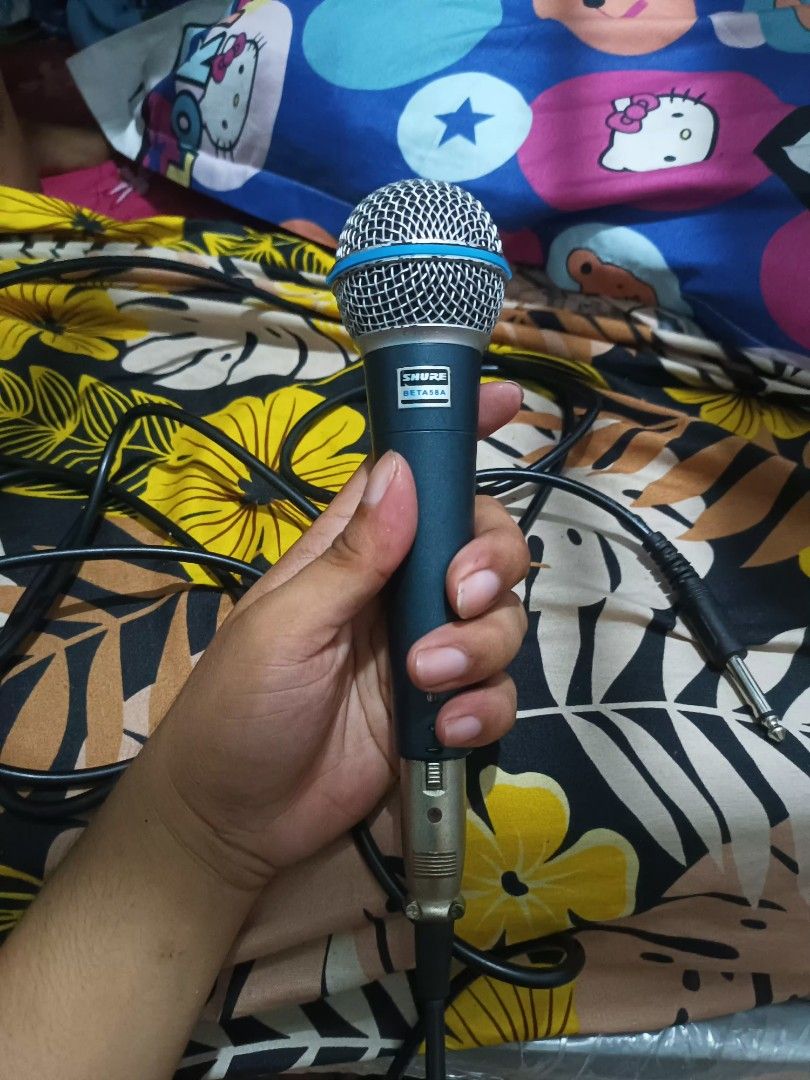 Shure SM58 Microphone with Cable Class A (Category: Microphones) located in Manila. Submitted by declutteringog7 (Listing ID 1420561290, Image 3). Description: - Shure SM58 vocal microphone - Features a durable blue handle and silver mesh head - Includes an XLR to 1/4 inch cable - Designed for vocal performances.