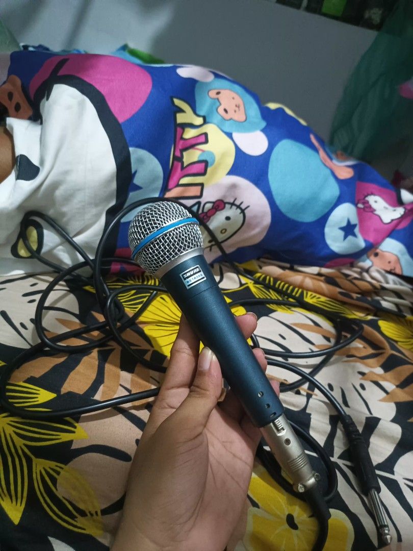 Shure SM58 Microphone with Cable Class A (Category: Microphones) located in Manila. Submitted by declutteringog7 (Listing ID 1420561290, Image 1). Description: - Shure SM58 vocal microphone - Features a durable blue handle and silver mesh head - Includes an XLR to 1/4 inch cable - Designed for vocal performances.