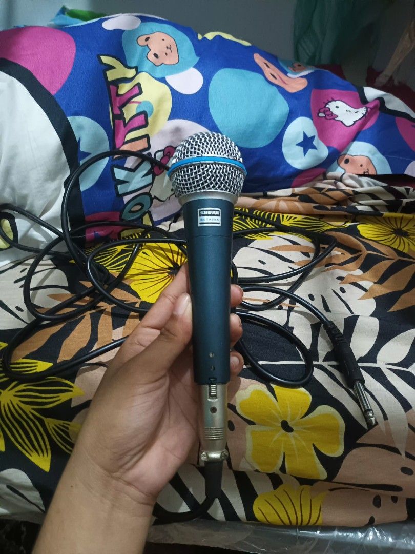 Shure SM58 Microphone with Cable Class A (Category: Microphones) located in Manila. Submitted by declutteringog7 (Listing ID 1420561290, Image 2). Description: - Shure SM58 vocal microphone - Features a durable blue handle and silver mesh head - Includes an XLR to 1/4 inch cable - Designed for vocal performances.