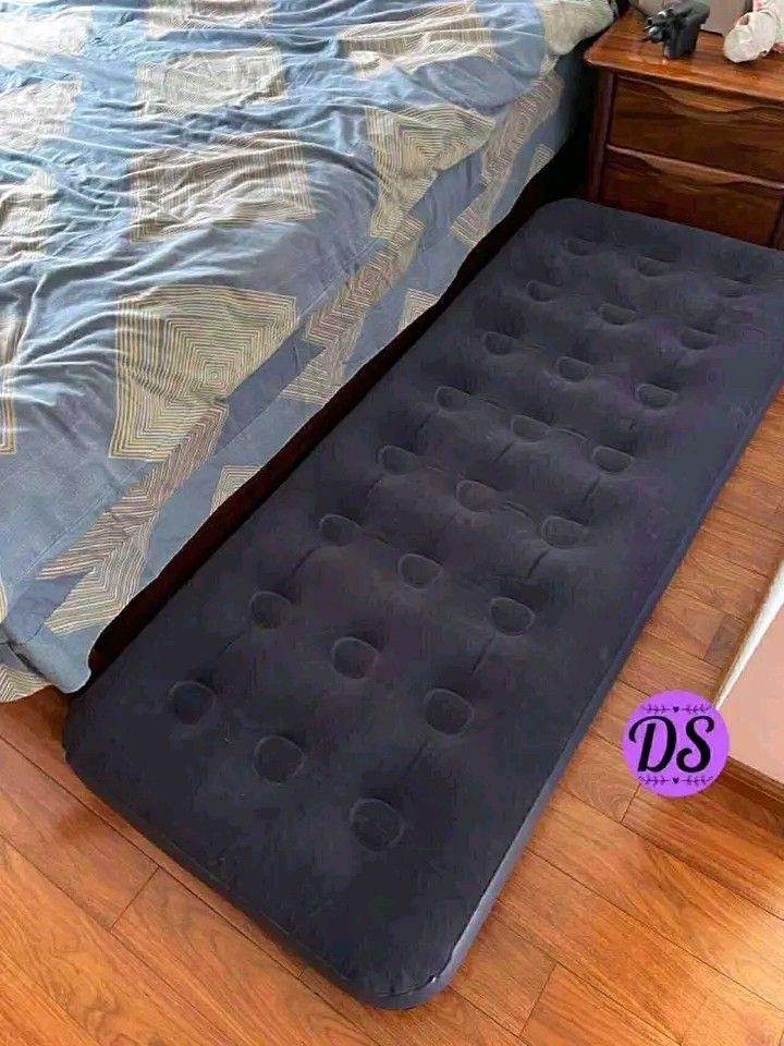 Single Inflatable Air Bed (Category: Bed Frames & Mattresses) located in Makati City. Submitted by oideme (Listing ID 1420666707, Image 3). Description: - Navy blue single-sized inflatable mattress. - Ideal for guests or travel. - Features a comfortable, textured surface. - Conveniently inflates and deflates for easy storage. - Shown with blanket and pillows (not included)..