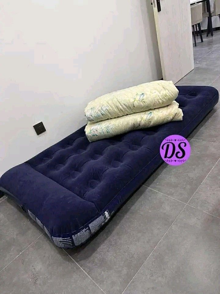 Single Inflatable Air Bed (Category: Bed Frames & Mattresses) located in Makati City. Submitted by oideme (Listing ID 1420666707, Image 1). Description: - Navy blue single-sized inflatable mattress. - Ideal for guests or travel. - Features a comfortable, textured surface. - Conveniently inflates and deflates for easy storage. - Shown with blanket and pillows (not included)..