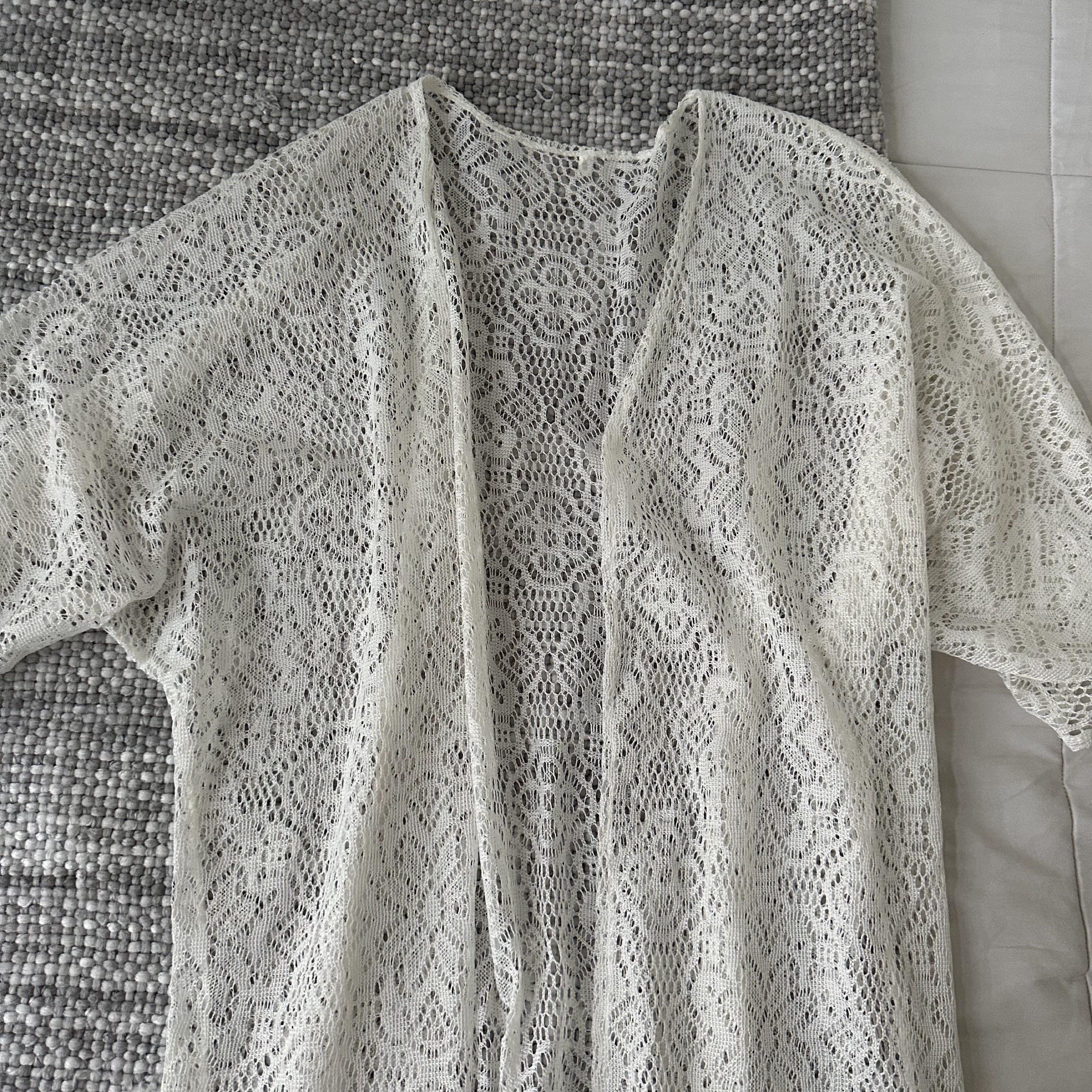 White Lace Kimono with Fringe (Category: Coats, Jackets and Outerwear) located in Marilao. Submitted by extra_stuff (Listing ID 1420583084, Image 2). Description: - White lace kimono - Flowing design - Short sleeves - Long, open front - Delicate fringe hem - Versatile for layering or beach cover-up.