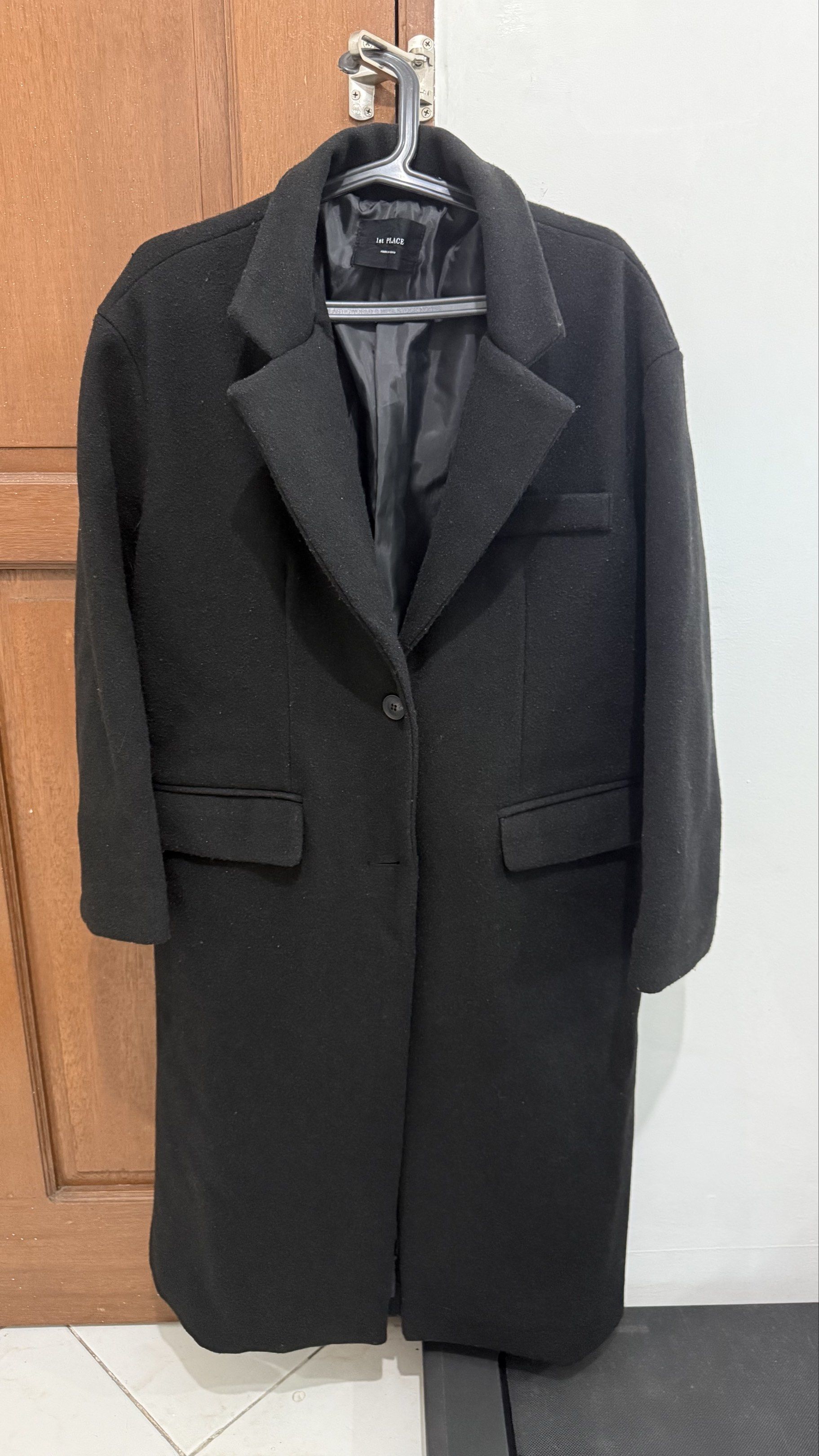 Winter/Cool Weather Black Long Coat (Category: Coats, Jackets and Outerwear) located in Pasay City. Submitted by konmari101 (Listing ID 1420633839, Image 1). Description: Product details: - Black long coat from 1st PLACE. - Features a classic lapel collar, single-button closure, and two front pockets. - The coat is made in South Korea. - The coat has a long length, extending past the knees. - It is a solid black color. - Used only three times. Or