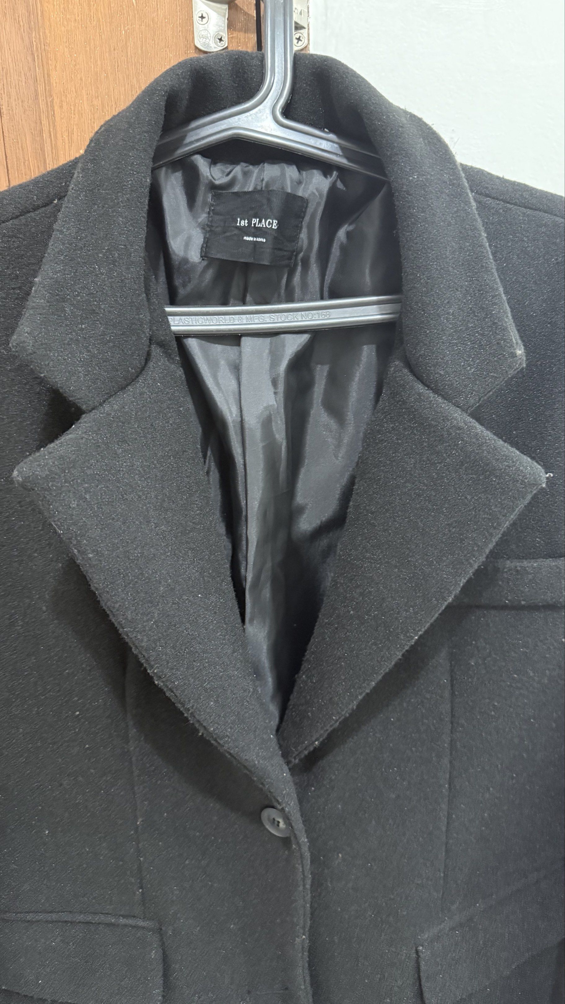 Winter/Cool Weather Black Long Coat (Category: Coats, Jackets and Outerwear) located in Pasay City. Submitted by konmari101 (Listing ID 1420633839, Image 2). Description: Product details: - Black long coat from 1st PLACE. - Features a classic lapel collar, single-button closure, and two front pockets. - The coat is made in South Korea. - The coat has a long length, extending past the knees. - It is a solid black color. - Used only three times. Or