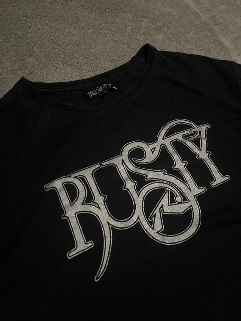 Y2K Vintage Rusty Surf tee/ shirt (Category: Tshirts & Polo Shirts ) located in Davao. Submitted by batz11 (Listing ID 1420744659, Image 3). Description: Y2K RUSTY Condition: Very good condition Color rate: 9.5/10 Dimensions: 21 x 28 21 width/ 28 length Issue: minor hairline, barely visible. (Check photos for reference) DAVAO CITY LOC. CAN SHIP THROUGH J&T PM IF INTERESTED 📥.