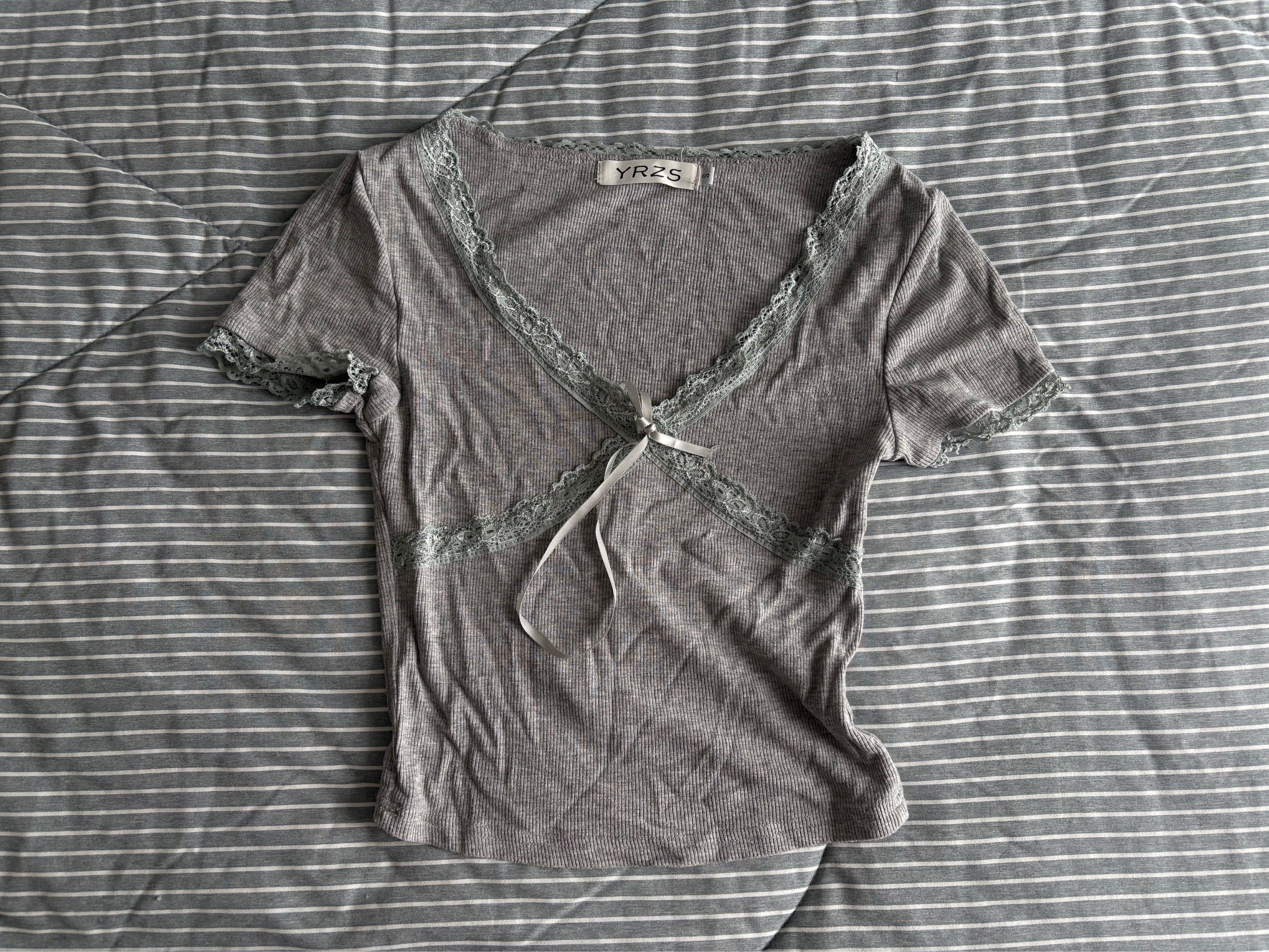 YRZS Grey Lace Trim Top (Category: Sleeveless) located in Taguig. Submitted by nikn00k (Listing ID 1420624177, Image 1). Description: - Grey top - Lace trim on neckline and sleeves - Tie closure - Short sleeves - Ribbed fabric - Brand tag visible.
