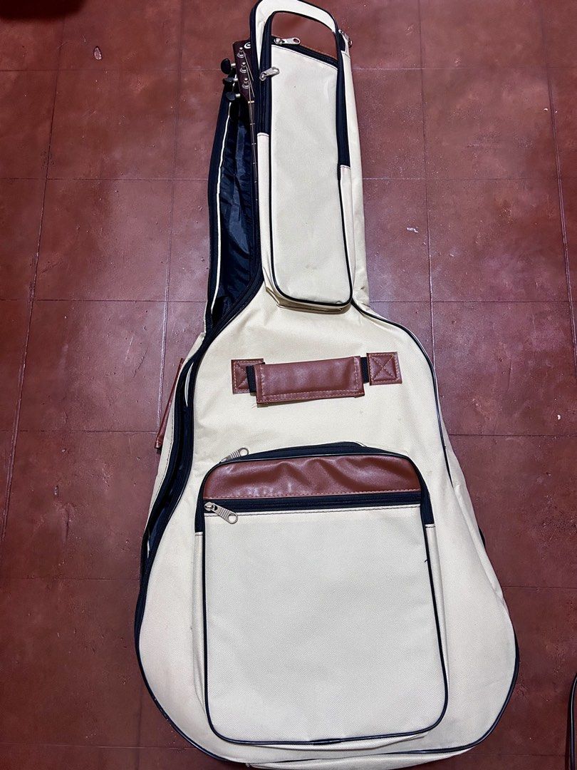 Acoustic Guitar Soft Case / Gig Bag (Category: Musical Instruments) located in Dumaguete. Submitted by bunchings.books (Listing ID 1424142238, Image 1). Description: 🎸 Acoustic Guitar Soft Case / Gig Bag 📏 Size: 1.05m x 43cm (fits standard full-size acoustic guitar) ✔ Padded interior ✔ Backpack straps ✔ Side handle ✔ Multiple zip pockets for tuner, capo, strings, etc. ✔ Zippers all working Condition: Lightly used. No tears. Minor creasing from 
